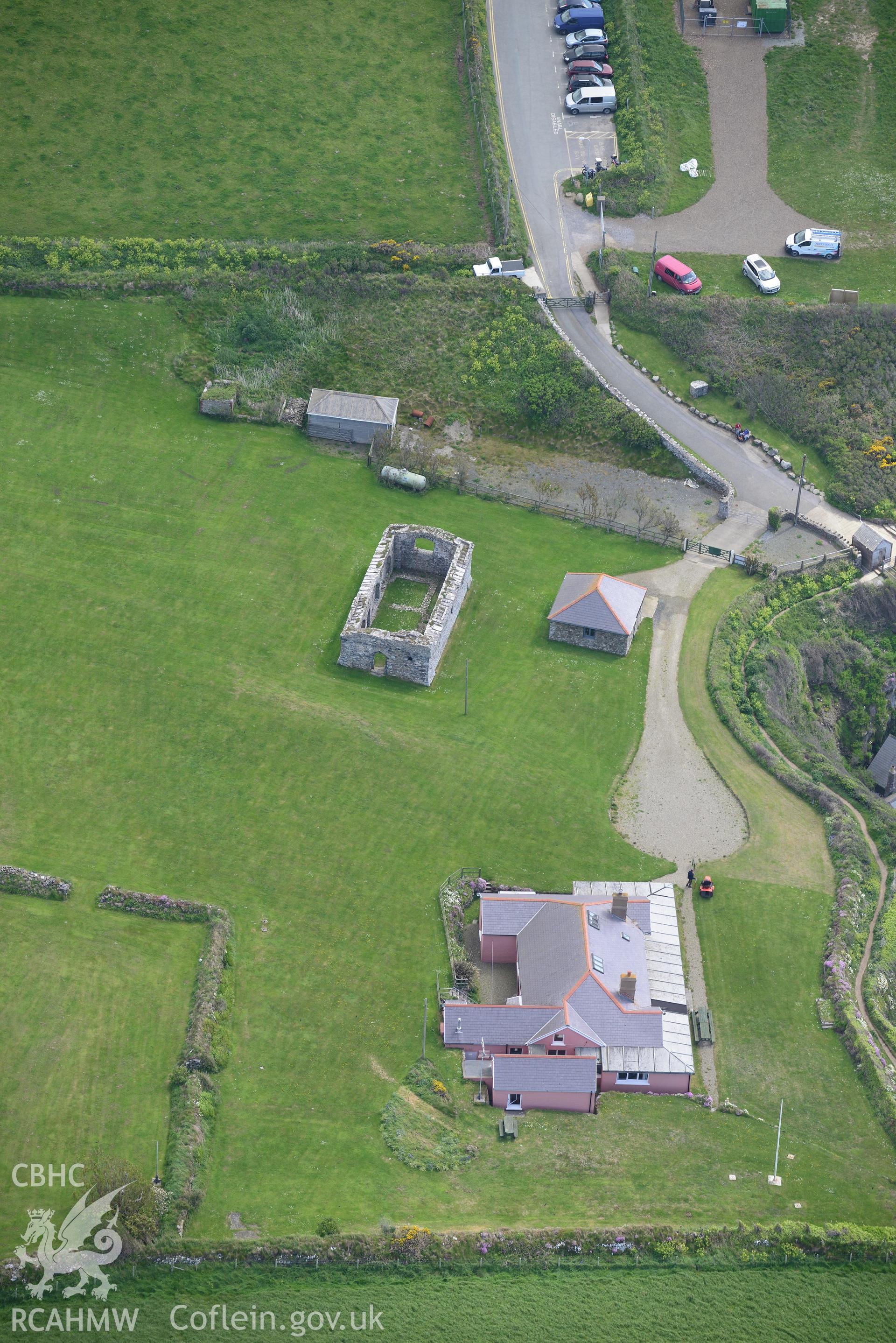 St. Justinian's bungalow and the remains of St. Justinian's chapel. Oblique aerial photograph taken during the Royal Commission's programme of archaeological aerial reconnaissance by Toby Driver on 13th May 2015.
