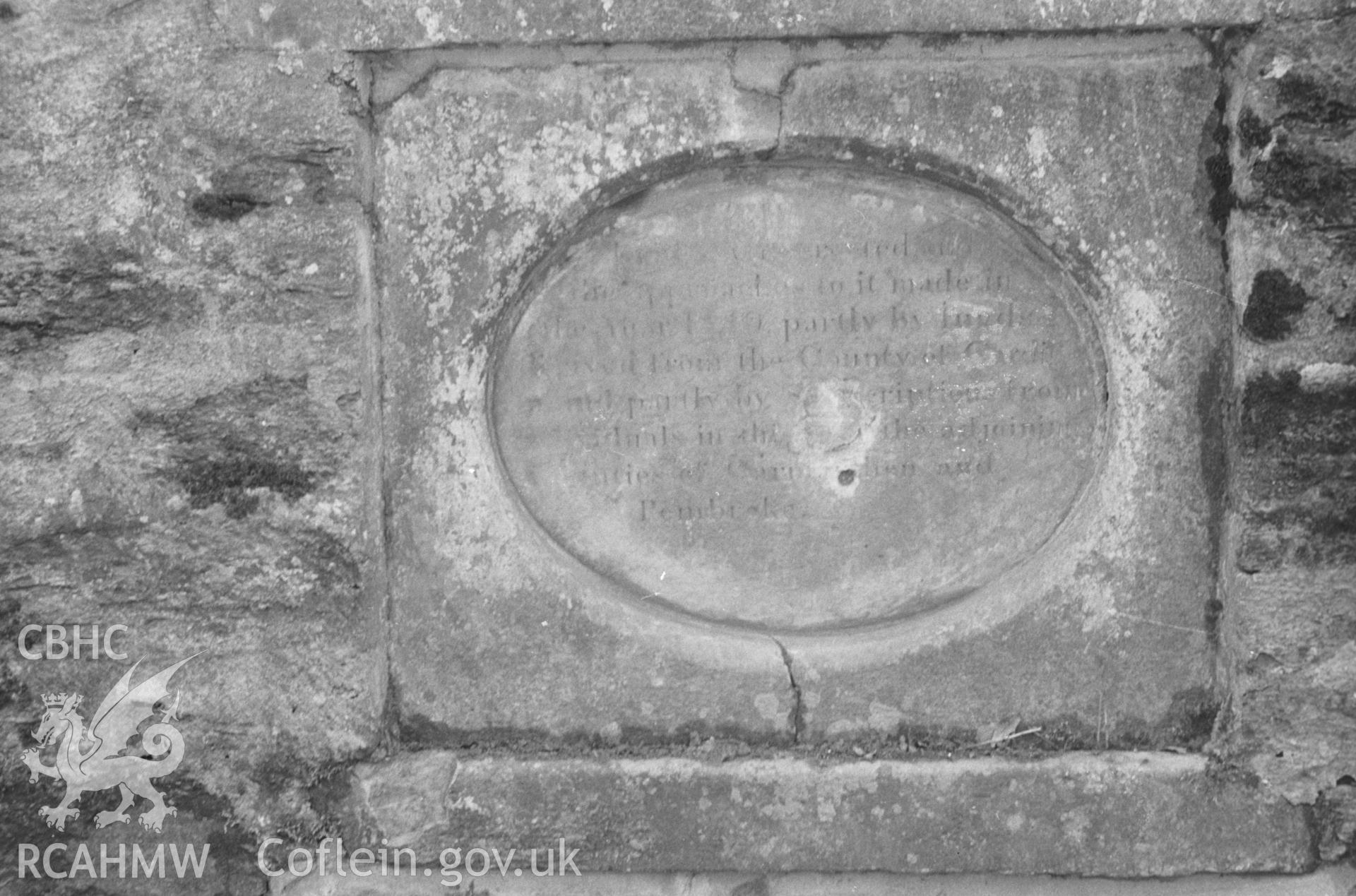Digital copy of a black and white negative showing slate plaque set in south western parapet of bridge at Felin Cwrrws over Nant Gwylan on the Henllan-Llandyfriog road. Photographed by Arthur O. Chater in April 1966. Grid Ref 354 412.