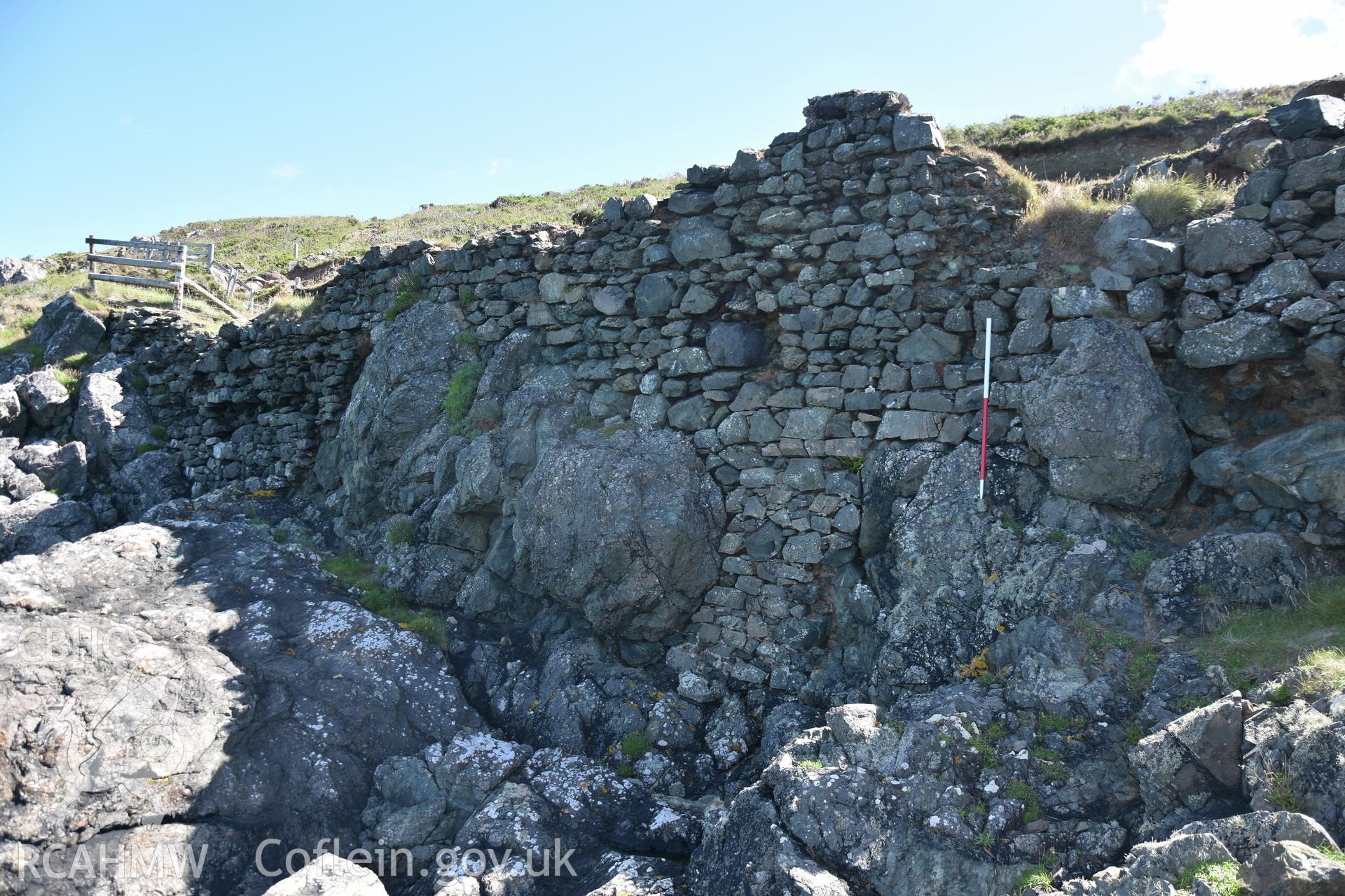 Penmaenmelyn copper mine. View of western revetment wall. 1m scale. Investigator?s photographic survey for the CHERISH Project. ? Crown: CHERISH PROJECT 2019. Produced with EU funds through the Ireland Wales Co-operation Programme 2014-2020. All material