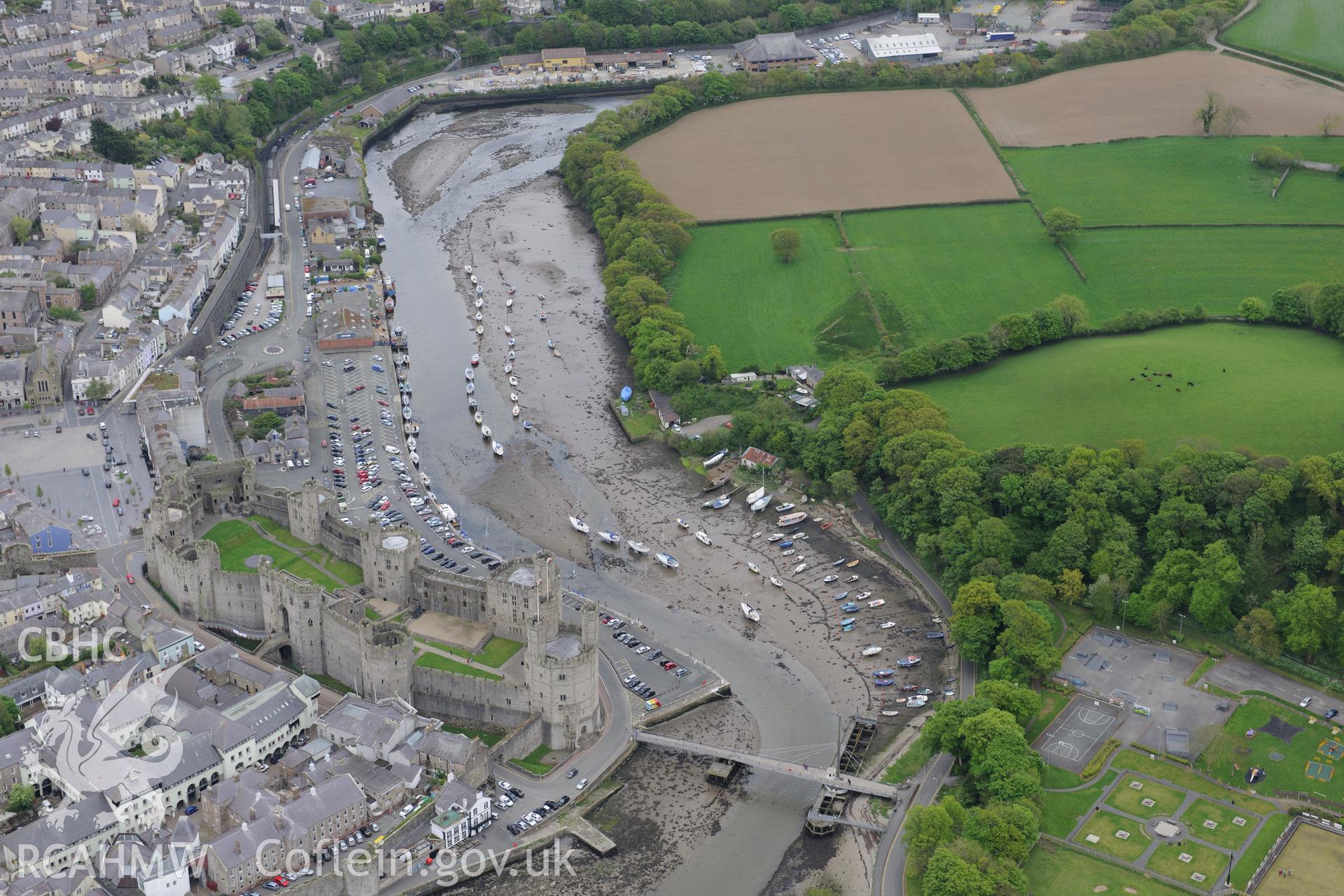 The town of Caernarfon, with the castle and the swing bridge visible. Oblique aerial photograph taken during the Royal Commission?s programme of archaeological aerial reconnaissance by Toby Driver on 22nd May 2013.