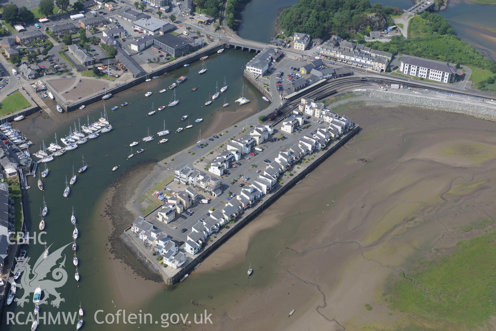 Porthmadog harbour and associated new Snowdon Wharf and railway station, Porthmadog. Oblique aerial photograph taken during the Royal Commission?s programme of archaeological aerial reconnaissance by Toby Driver on 12th July 2013.