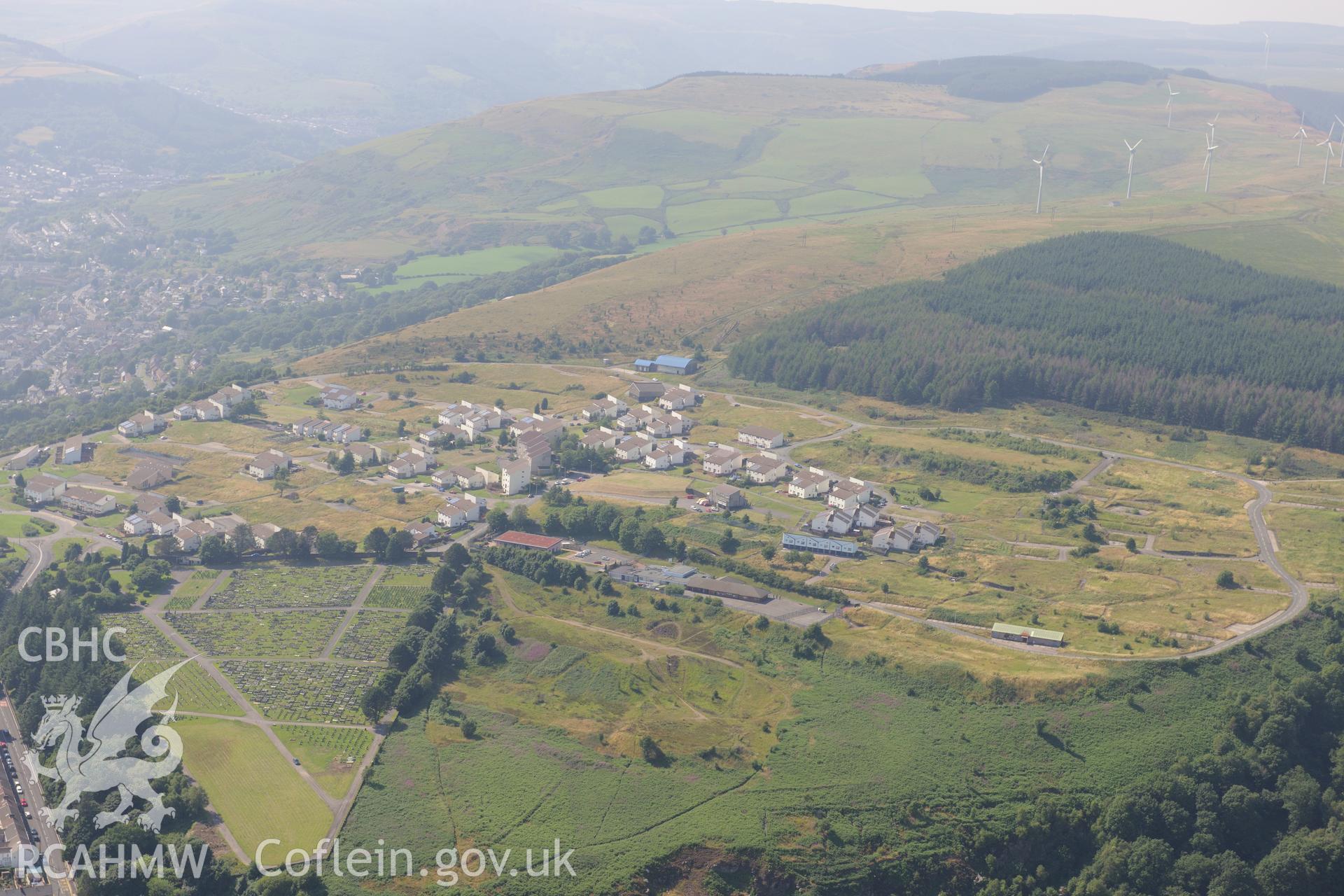 Penrhys, including view of the primary school and cemetery, on the western edge of Tylorstown, in the Rhondda Valley. Oblique aerial photograph taken during the Royal Commission?s programme of archaeological aerial reconnaissance by Toby Driver on 1st August 2013.