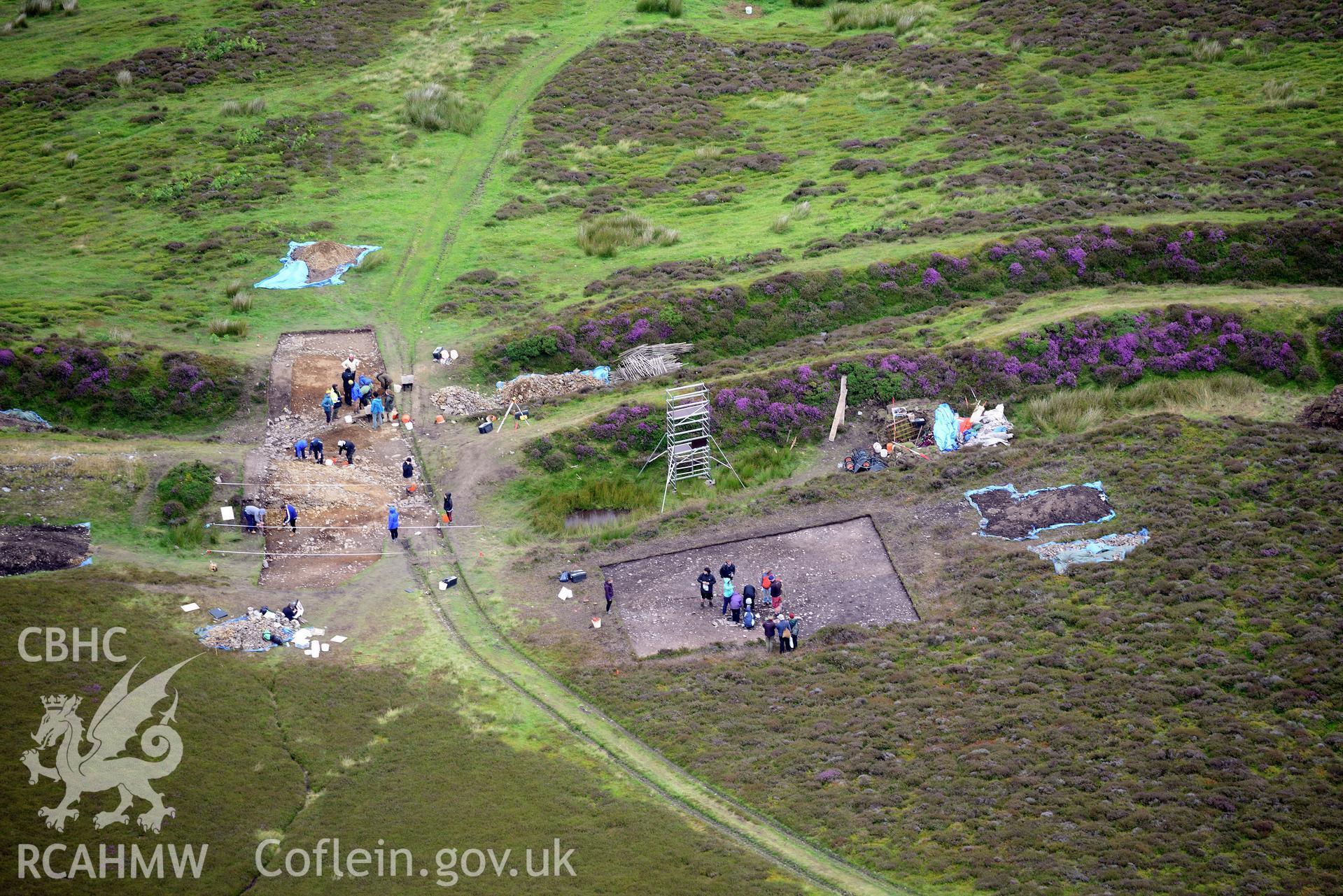 Penycloddiau Hilfort and Hut Platform V, Llangwyfan. Excavation by Liverpool University. Oblique aerial photograph taken during the Royal Commission's programme of archaeological aerial reconnaissance by Toby Driver on 30th July 2015.