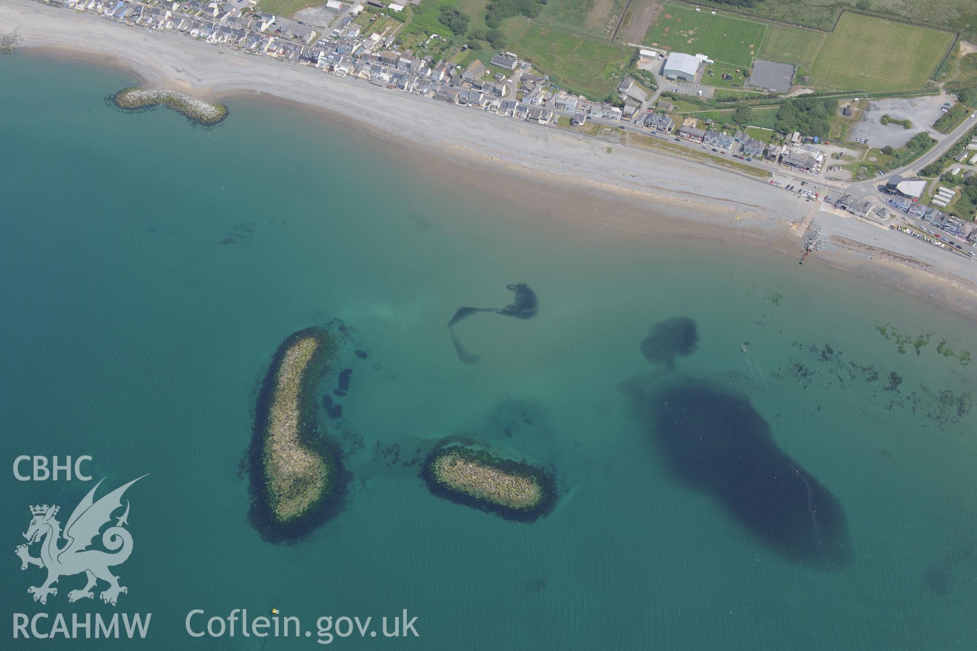 Coastal defences and the village of Borth. Oblique aerial photograph taken during the Royal Commission?s programme of archaeological aerial reconnaissance by Toby Driver on 12th July 2013.