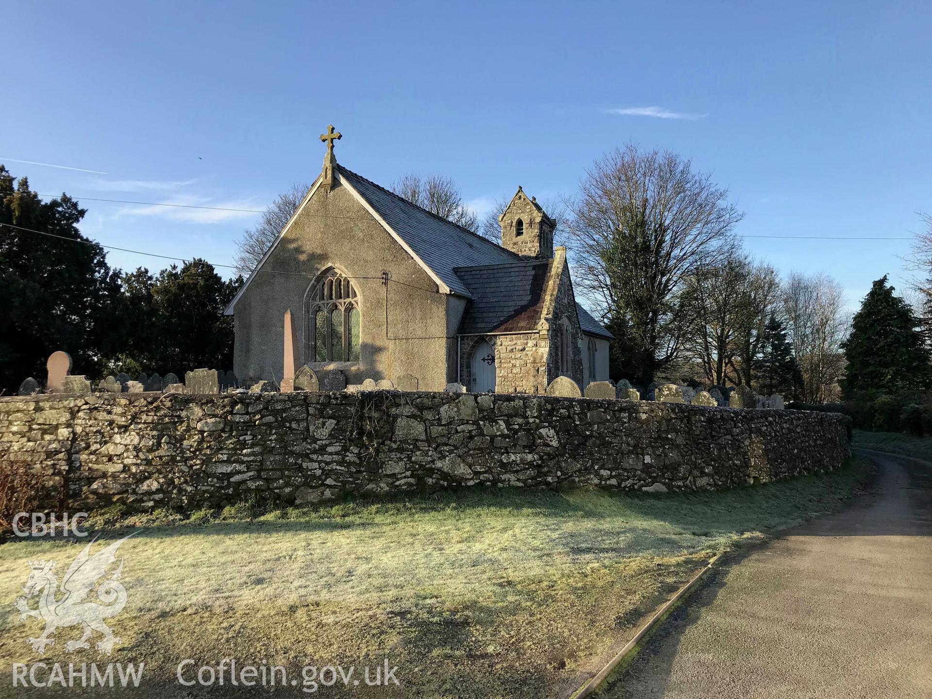 View from the north west showing exterior rear elevation of St. Cadfan's church, its graveyard and its boundary wall, Llangadfan. Colour photograph taken by Paul R. Davis on 2nd January 2019.
