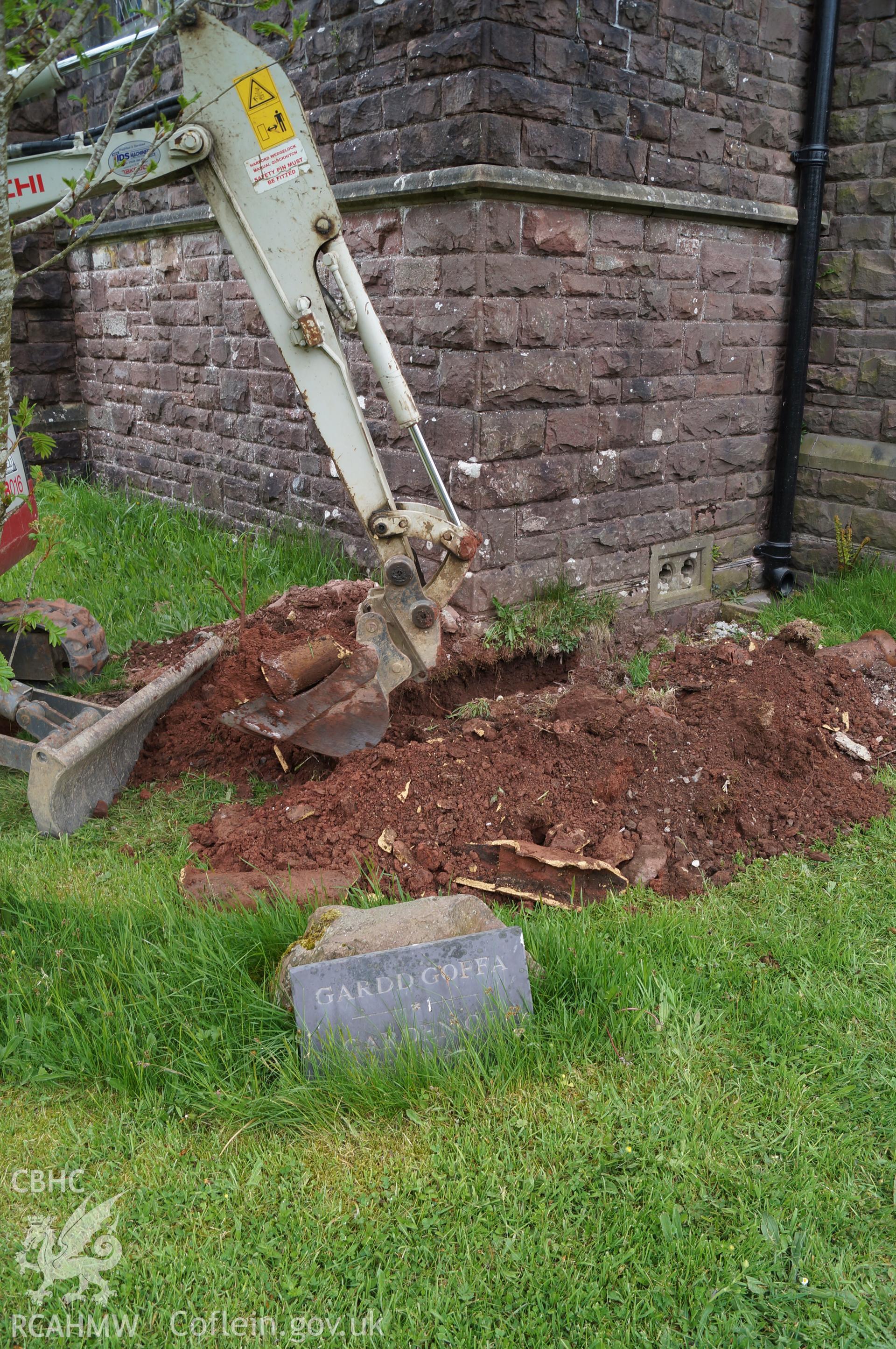 'Trench 2, removing the broken, silted-up ceramic drainpipe, looking northeast' at Capel Gwynfe, Llangadod. Photograph and description by Jenny Hall and Paul Sambrook of Trysor, May 2018.