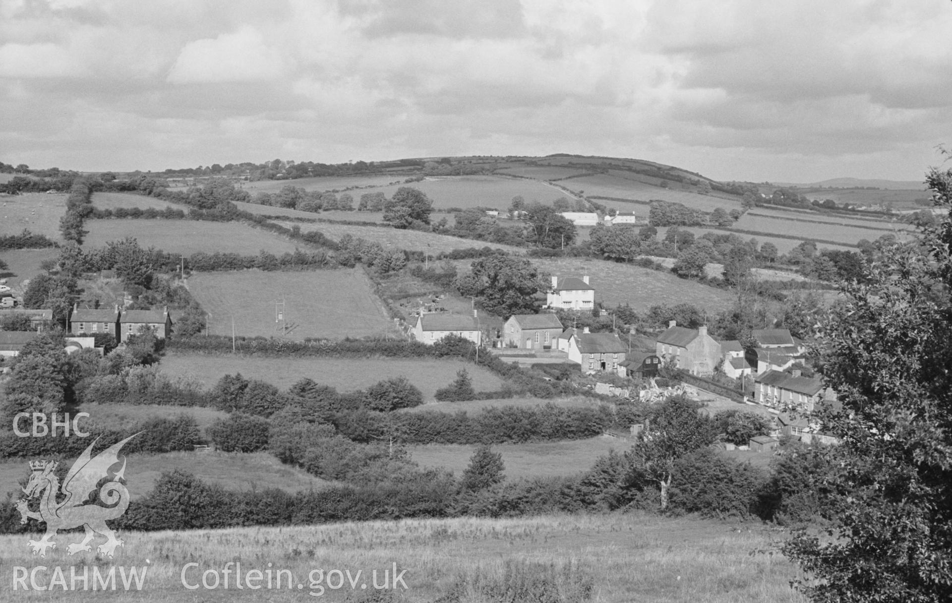 Digital copy of a black and white negative showing view from Cribyn Gaer, looking over Cribyn village; Cribyn Clota camp on right of highest point of skyline. (Looking east north east from Grid Reference SN 520 509) Photographed by Arthur O. Chater in August 1967.