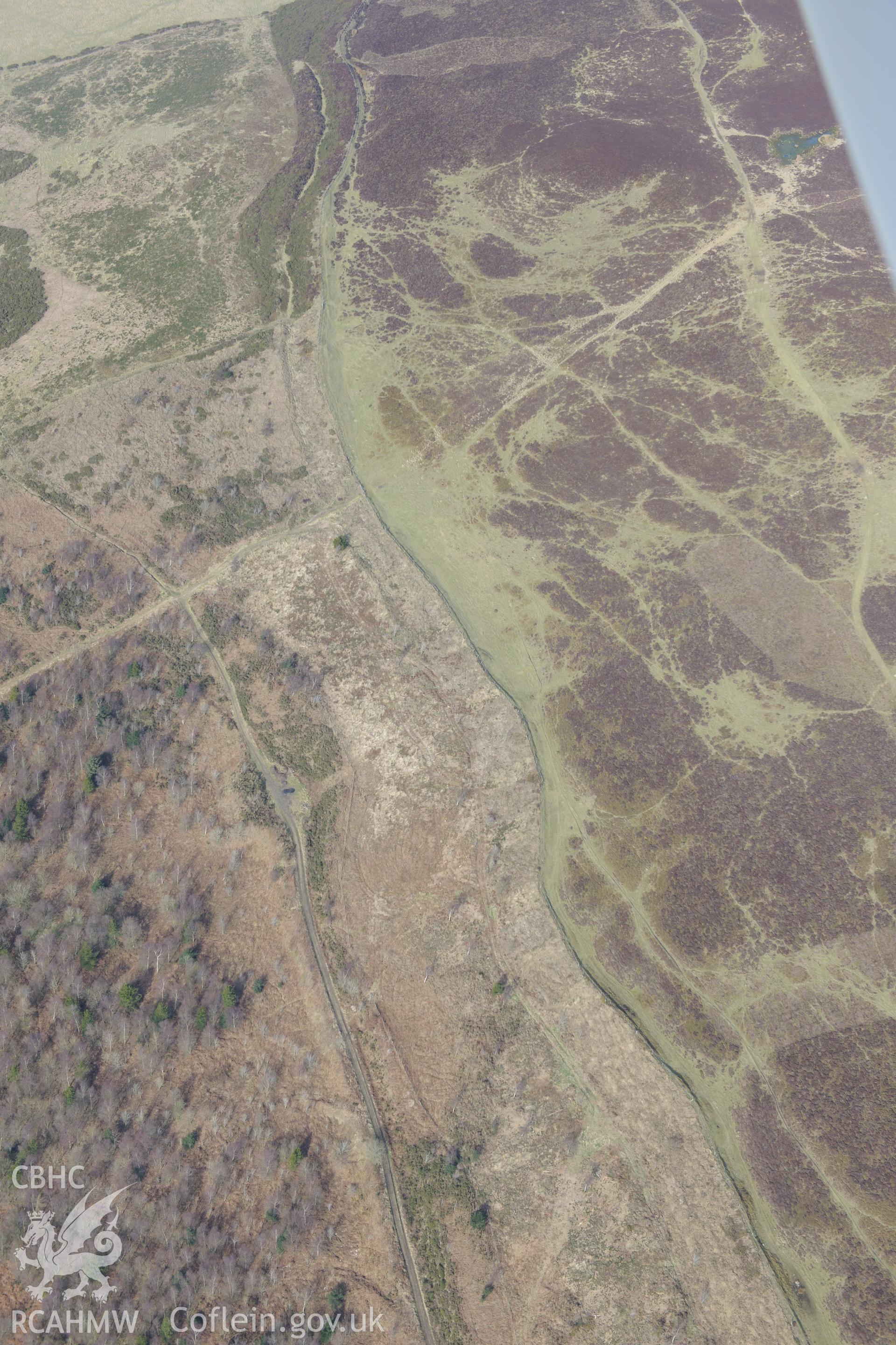 Western defences at Penycloddiau hillfort, Llangwyfan. Oblique aerial photograph taken during the Royal Commission?s programme of archaeological aerial reconnaissance by Toby Driver on 28th February 2013.