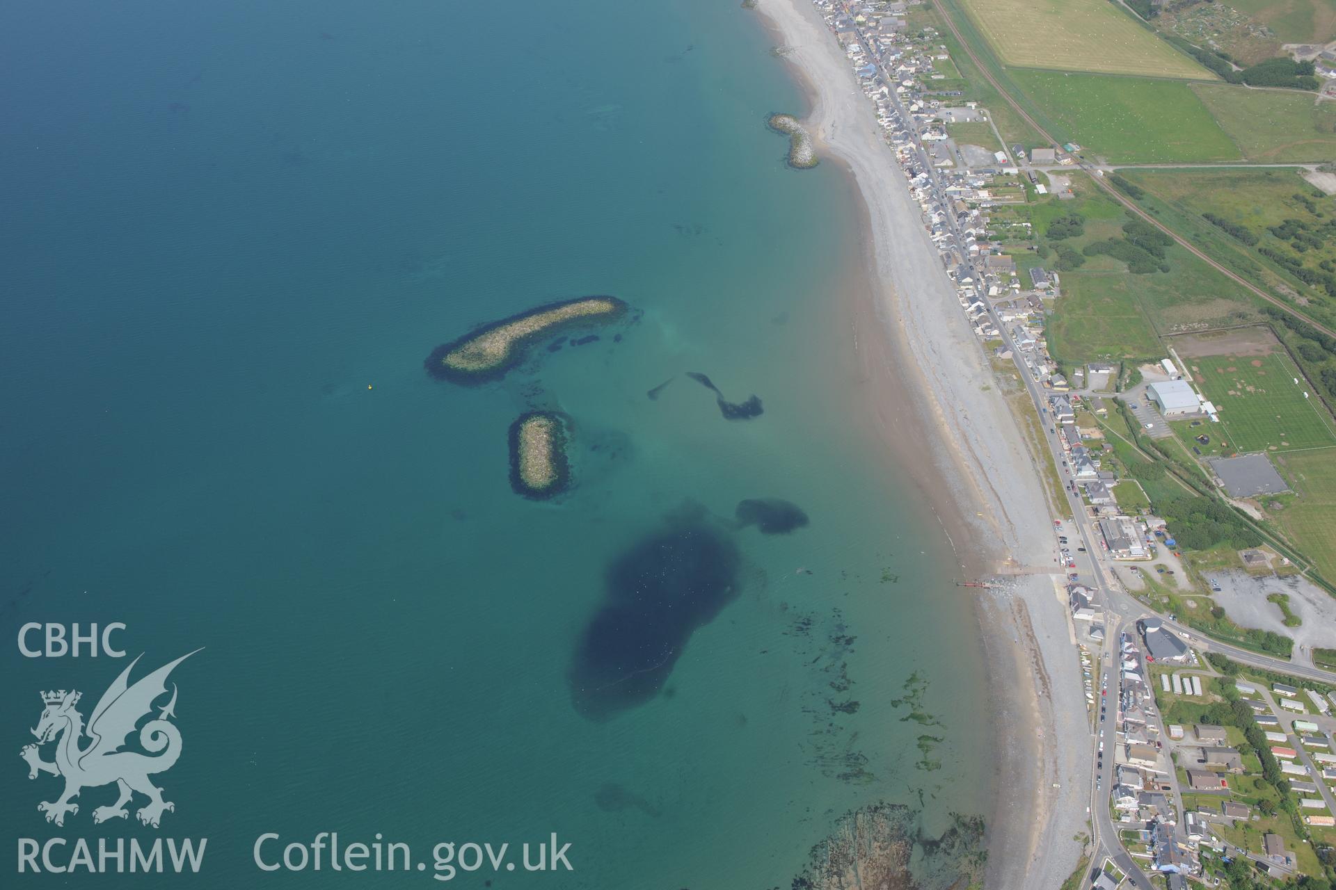 Coastal defences and the village of Borth. Oblique aerial photograph taken during the Royal Commission?s programme of archaeological aerial reconnaissance by Toby Driver on 12th July 2013.