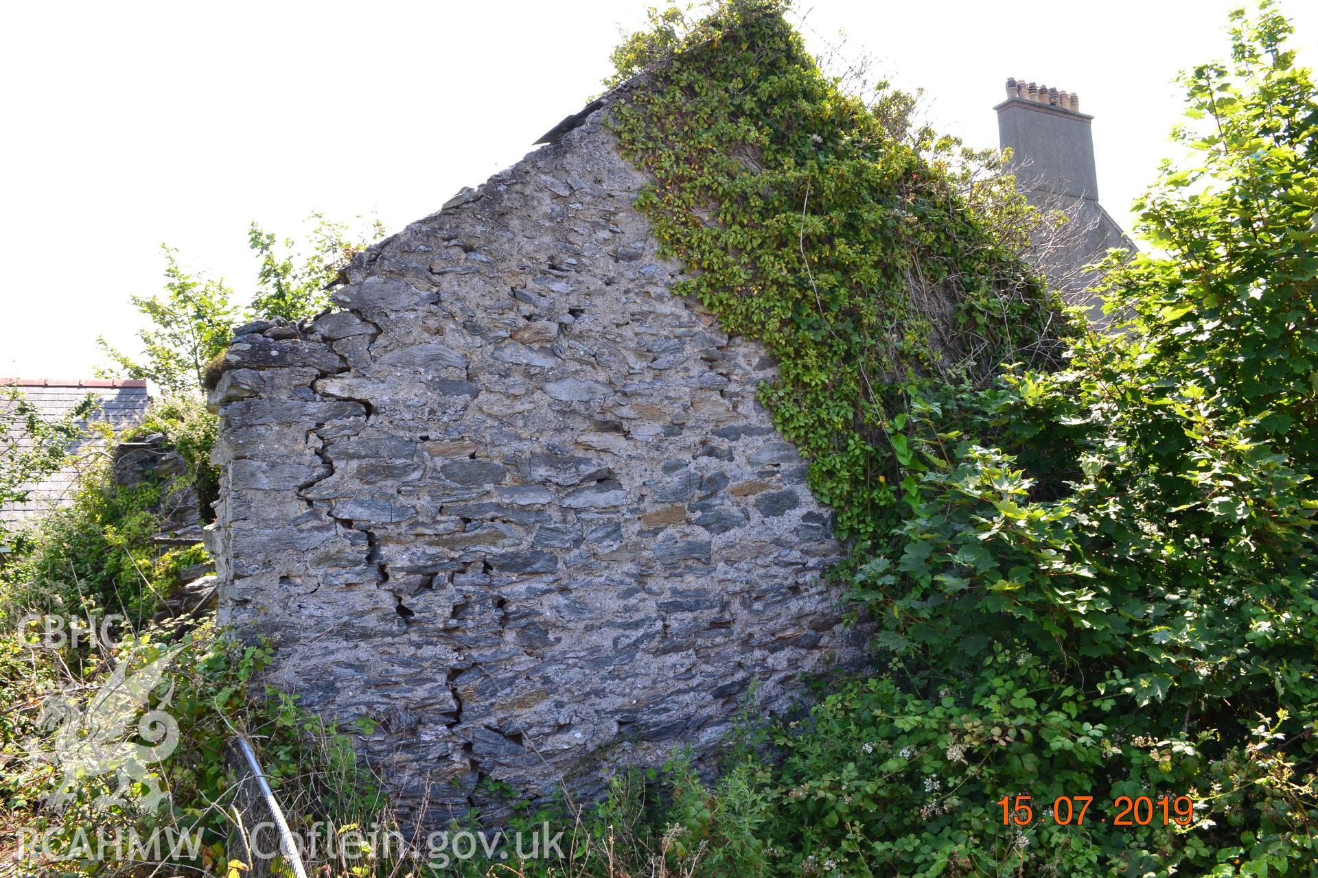 Digital colour photograph showing western elevation of the old garage at Fron Deg, Caergeiliog, Ynys Mon. Produced by Gerwyn Williams to meet a condition attached to a planning application, 2019.