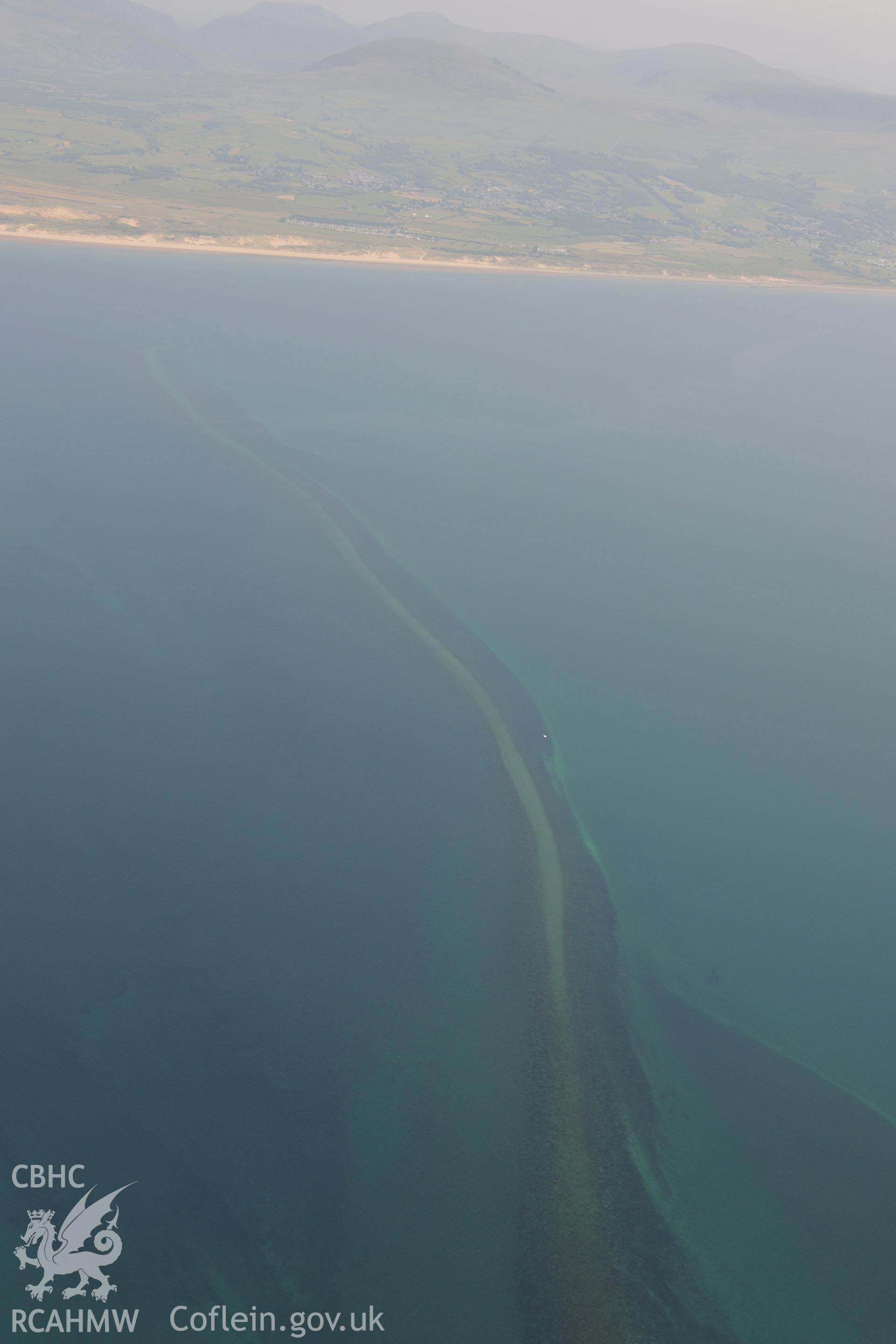 Sarn Padrig Reef, off the coast of Llaneddwyn, Dyffryn Ardudwy, Gwynedd. Oblique aerial photograph taken during the Royal Commission?s programme of archaeological aerial reconnaissance by Toby Driver on 12th July 2013.