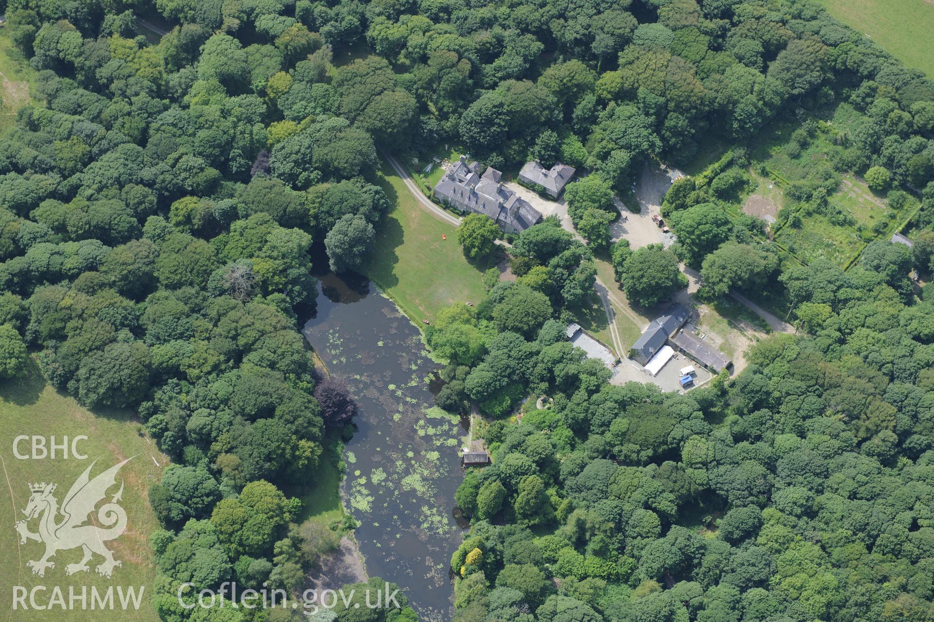 The lodge and garden at Llynnon Hall, Llanddeusant, north east of Holyhead. Oblique aerial photograph taken during the Royal Commission?s programme of archaeological aerial reconnaissance by Toby Driver on 12th July 2013.