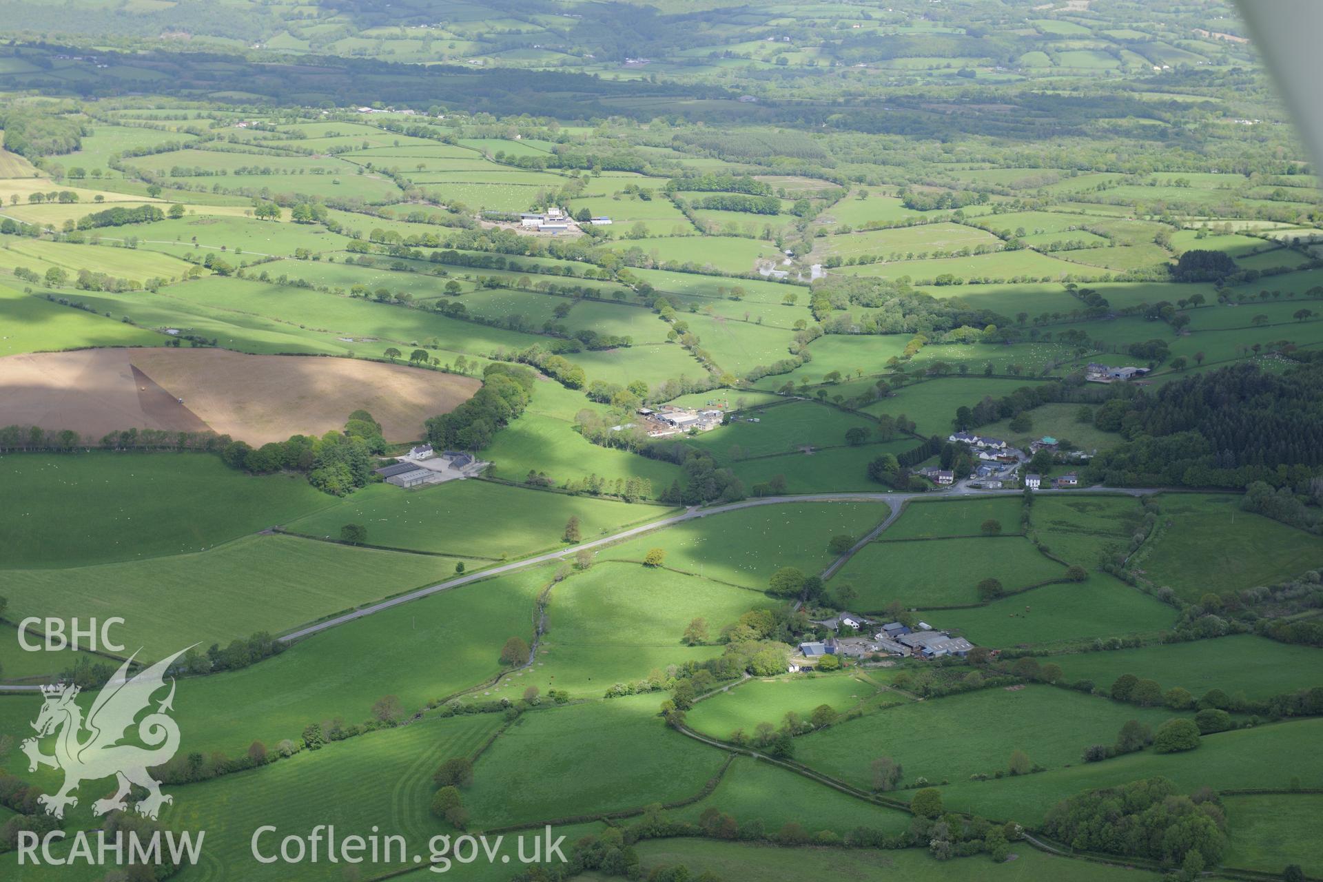 Landscape view of Teifi Valley including Olmarch hamlet and the old site of the Olmarch Railway Halt at Olmarch Fawr farm. Oblique aerial photograph taken during the Royal Commission's programme of archaeological aerial reconnaissance by Toby Driver on 3rd June 2015.