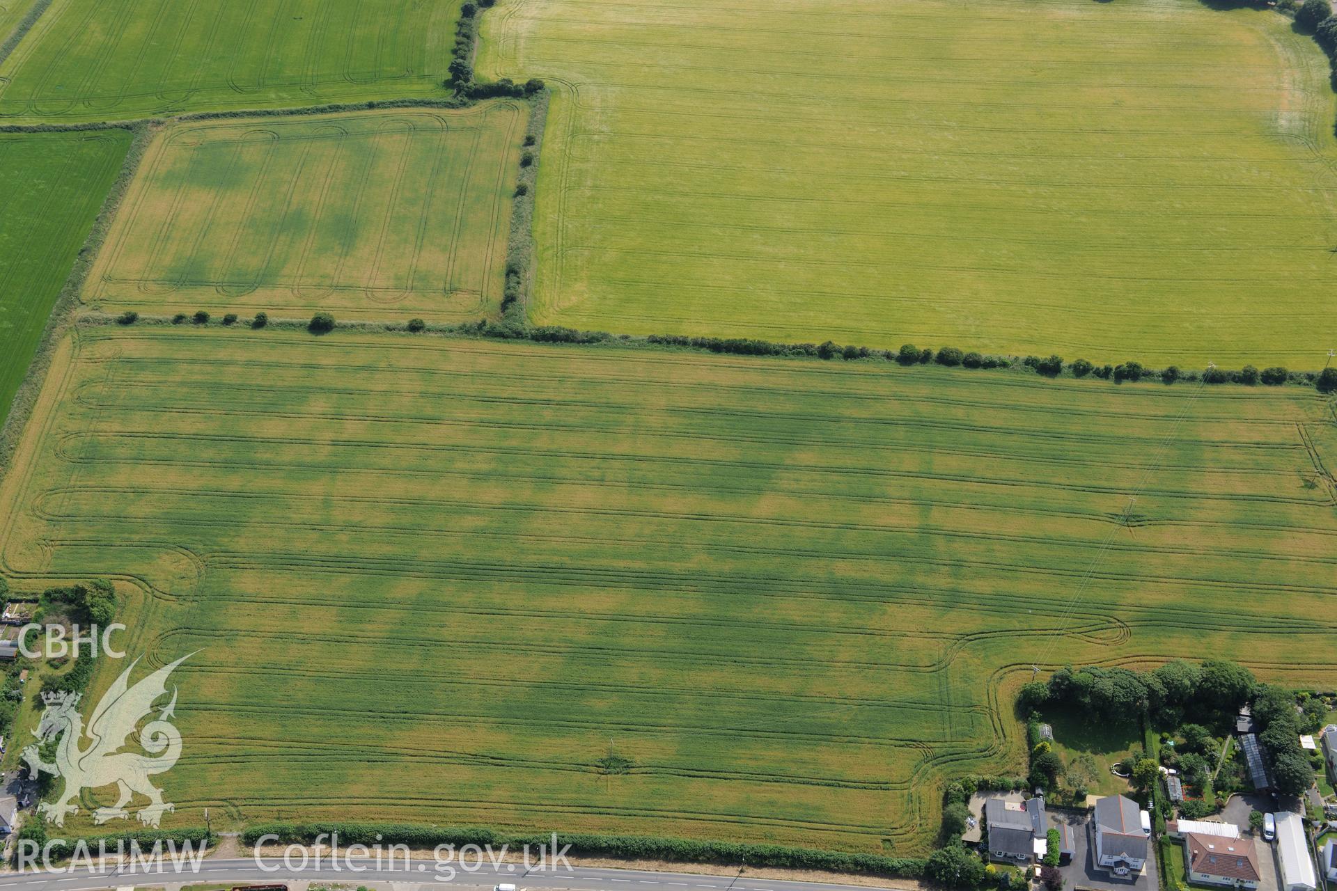 Hearson Farm defended enclosures, Hill Mountain, north east of Milford Haven. Oblique aerial photograph taken during the Royal Commission?s programme of archaeological aerial reconnaissance by Toby Driver on 16th July 2013.