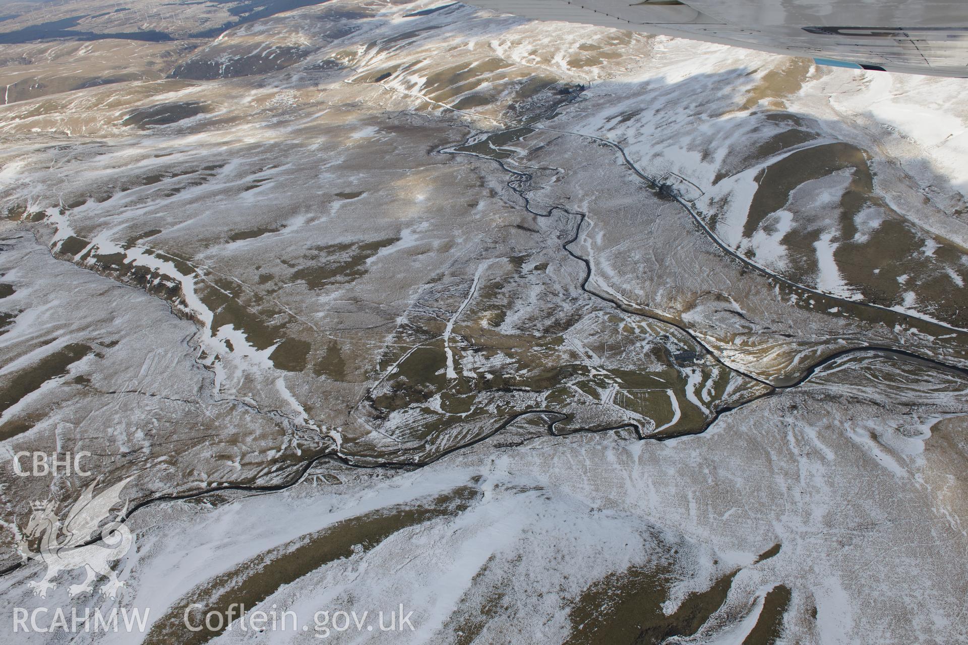 Abergwngu farmstead with associated field system and trackway, south west of Llangurig. Oblique aerial photograph taken during the Royal Commission's programme of archaeological aerial reconnaissance by Toby Driver on 2nd April 2013.