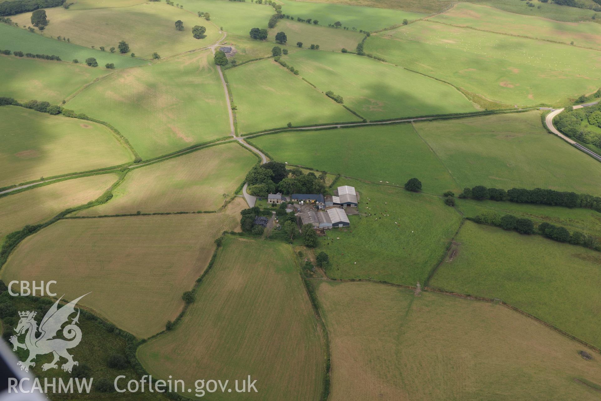 Caerau Roman military settlement or fort, and Twdin motte, Caerau, west of Builth Wells. Oblique aerial photograph taken during the Royal Commission?s programme of archaeological aerial reconnaissance by Toby Driver on 1st August 2013.