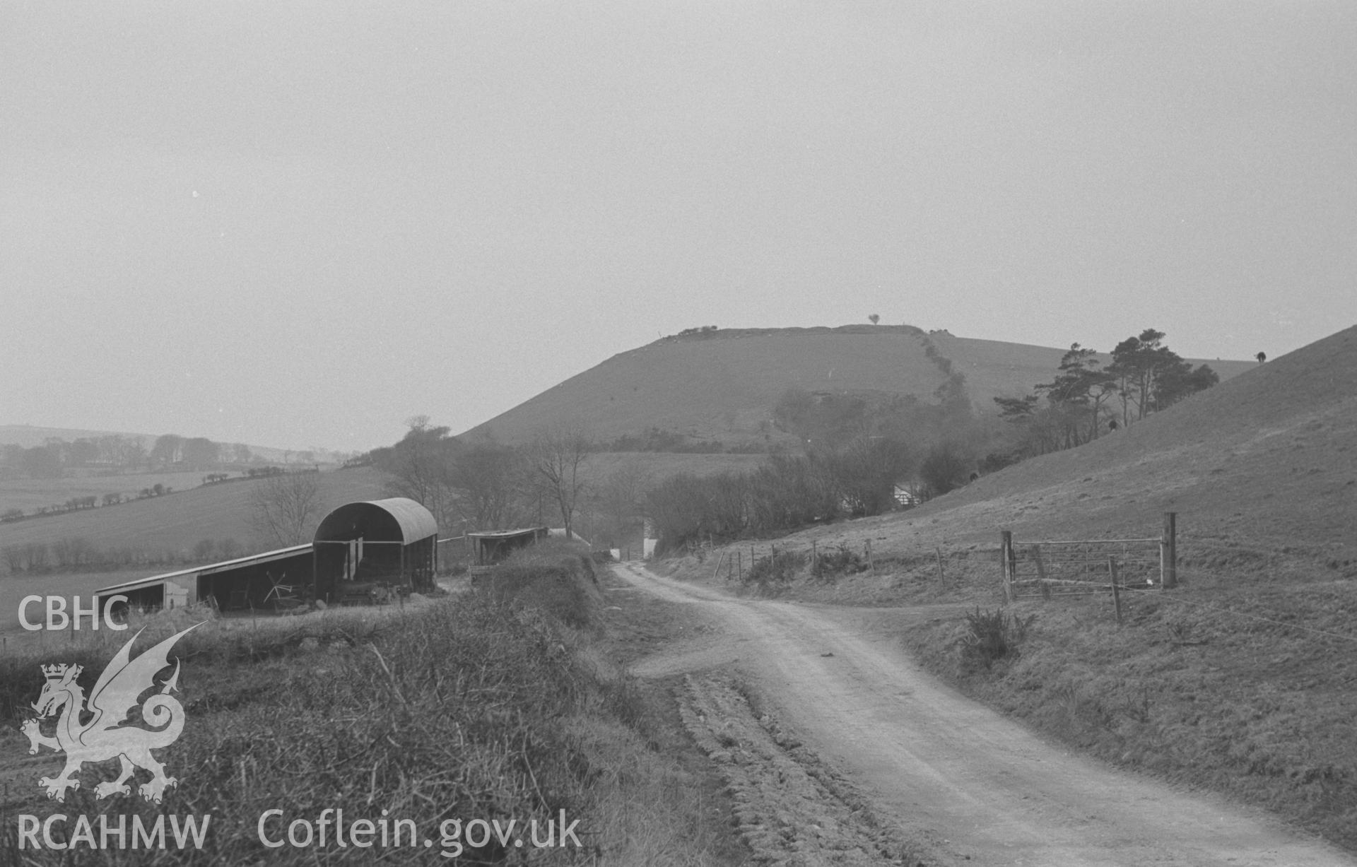 Digital copy of a black and white negative showing Castell Moeddyn fawr, south east of New Quay. Photographed in April 1964 by Arthur O. Chater from the lane 200m east of Moeddyn-Fawr farm at Grid Reference SN 4900 5205, looking west south west.