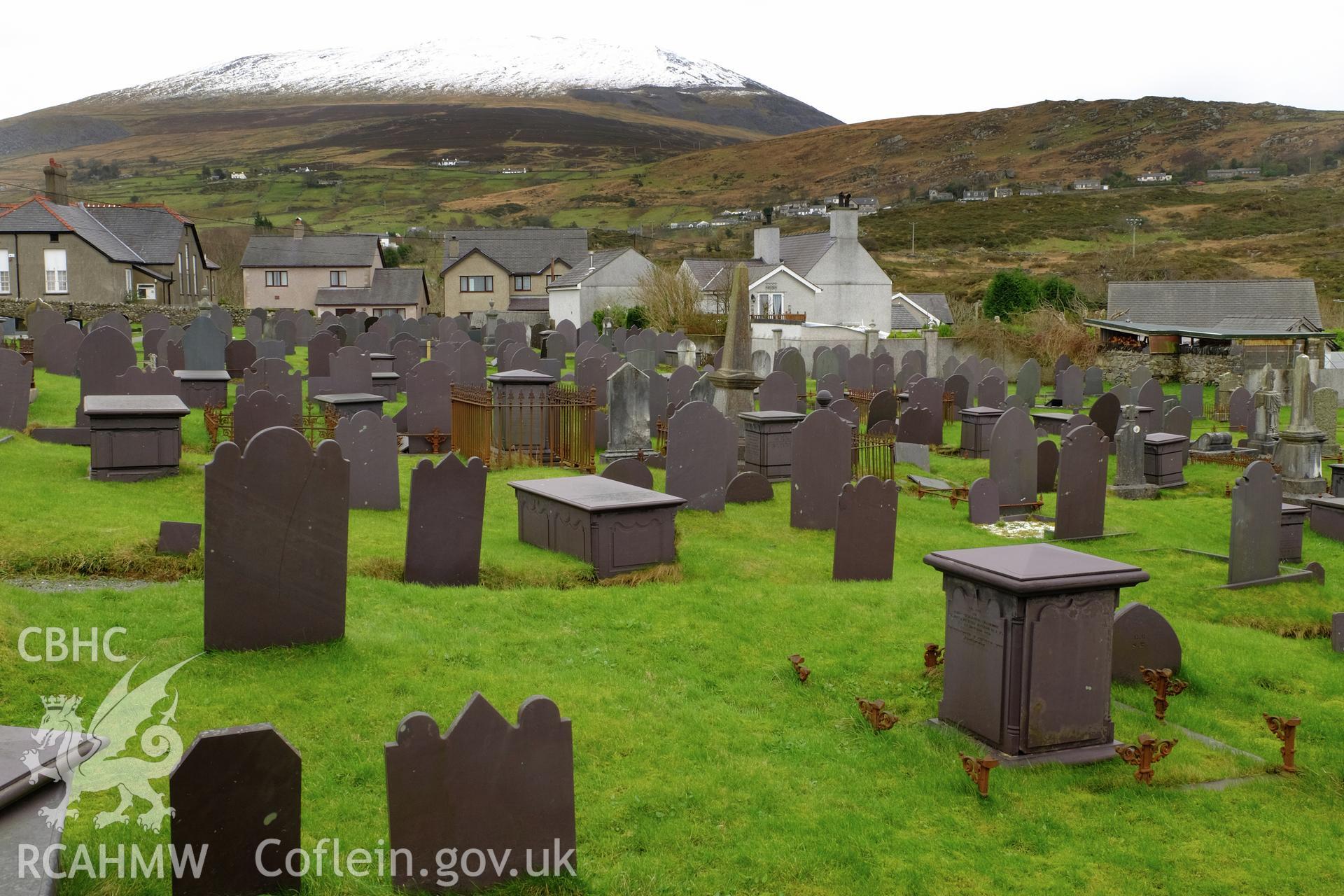 Colour photograph showing view looking south east at headstones in Macpela Cemetery, Deiniolen, produced by Richard Hayman 2nd March 2017