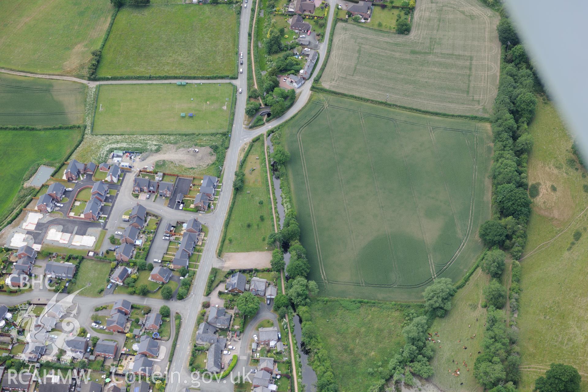 The village of Llanymynech on the Welsh-English border, south west of Oswestry. Oblique aerial photograph taken during the Royal Commission's programme of archaeological aerial reconnaissance by Toby Driver on 30th June 2015.