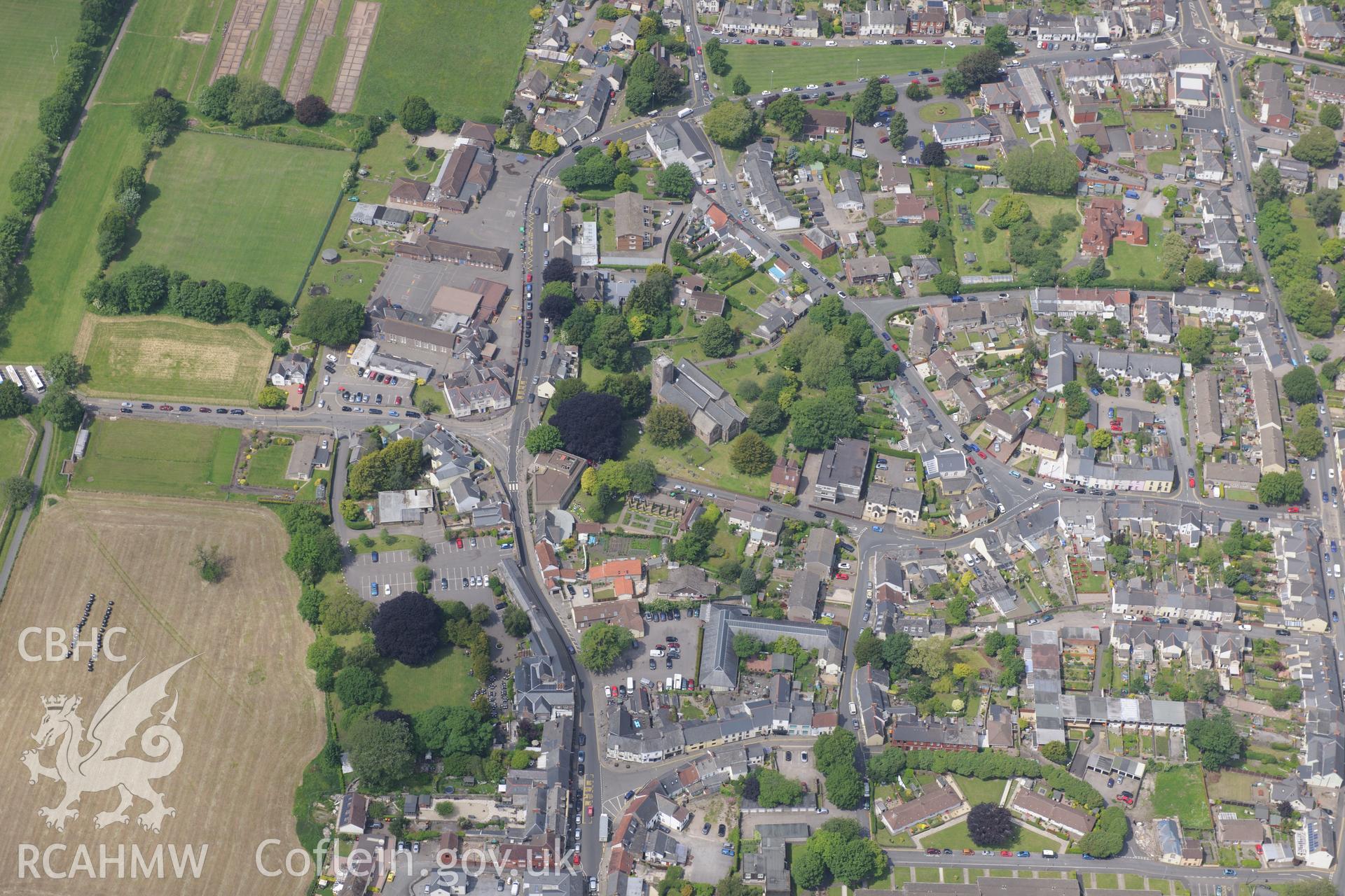 Caerleon town including views of the Roman barracks and St. Cadoc's Church. Oblique aerial photograph taken during the Royal Commission's programme of archaeological aerial reconnaissance by Toby Driver on 11th June 2015.