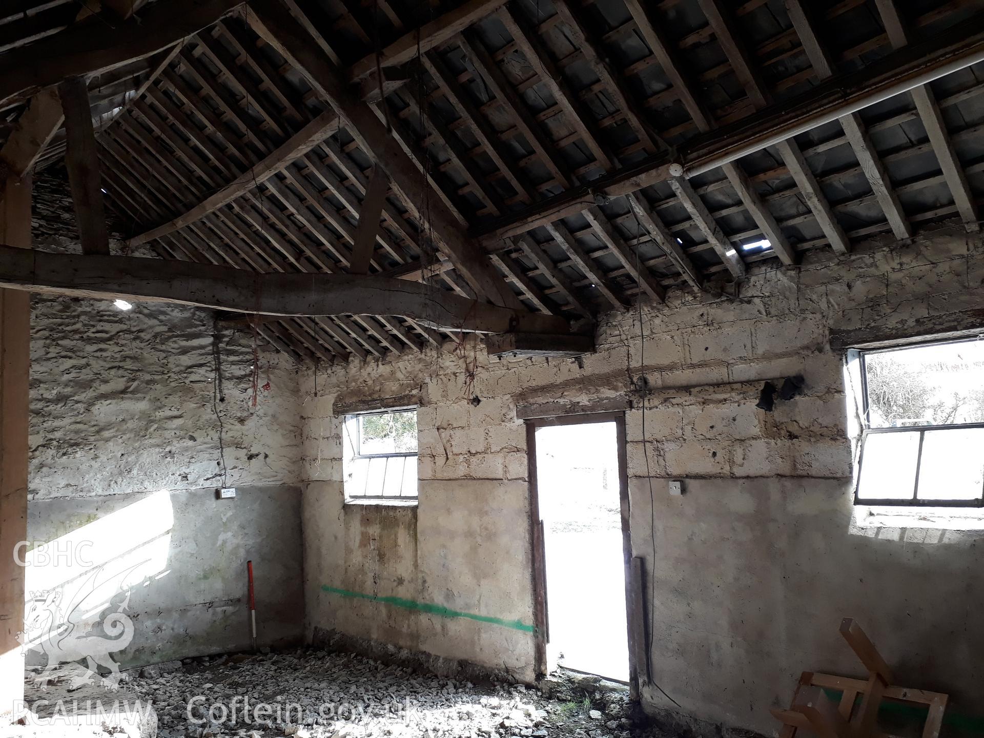 Barn interior with breeze block frontage, view north east. 1m scale. Photographed as part of archaeological building recording conducted at Bryn Ysguboriau, Llanelidan, Denbighshire, carried out by Archaeology Wales, 2018. Project no. P2587.