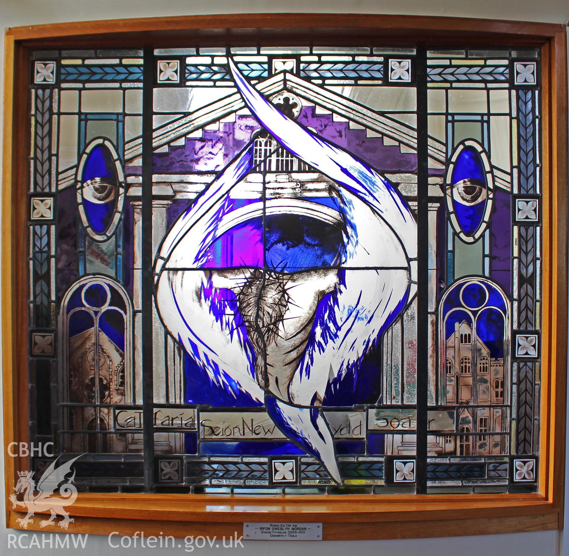Stained glass window memorial. Inscription-Calfaria Seion Newydd Soar. Plaque: Rhodd Er Cof Am IRFON GWERSLYN MORGAN Diacon Ffyddlon (1956-80) Oddiwrth y Teulu. Photographic survey of Seion Baptist Chapel, Morriston, conducted by Sue Fielding 13/5/2017.