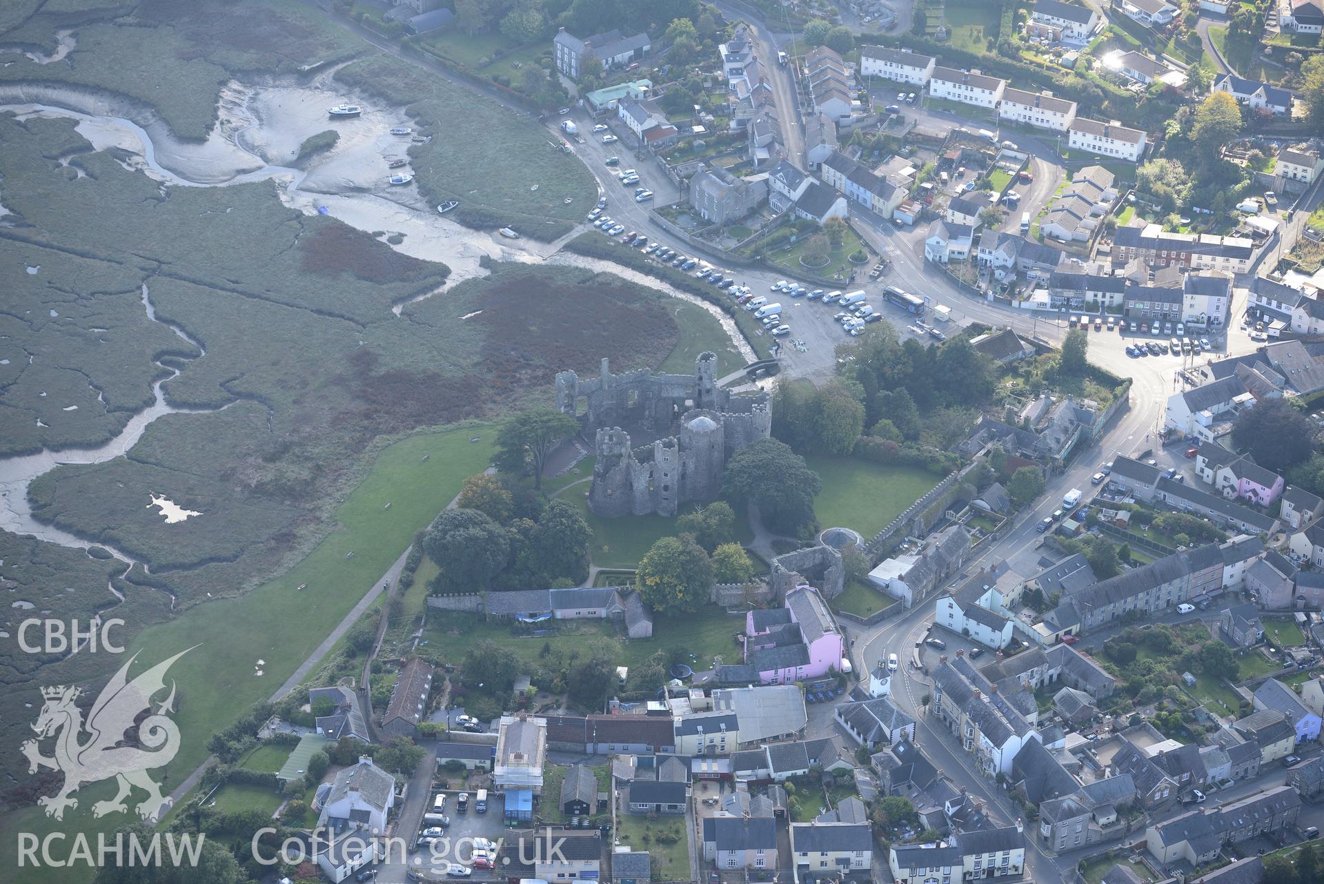 Laugharne Castle, Castle House and the surrounding town. Oblique aerial photograph taken during Royal Commission's programme of archaeological aerial reconnaissance by Toby Driver on 30th September 2015.