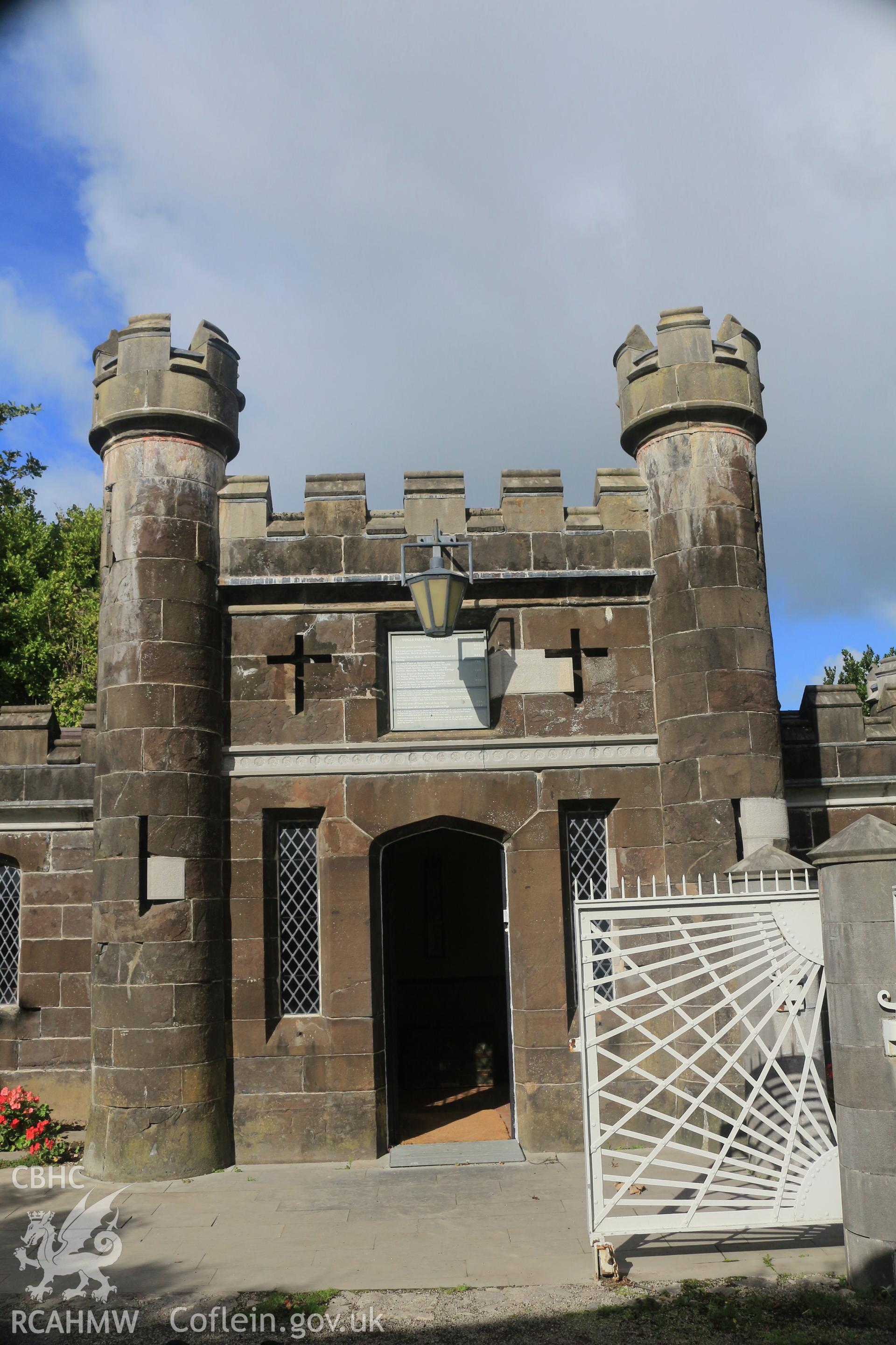 Investigator photographs of Conwy Suspension Bridge Keepers cottage. Exterior: gatekeeper's cottage and opened pedestrian gate showing Thomas Telford's iconic sunburst design.