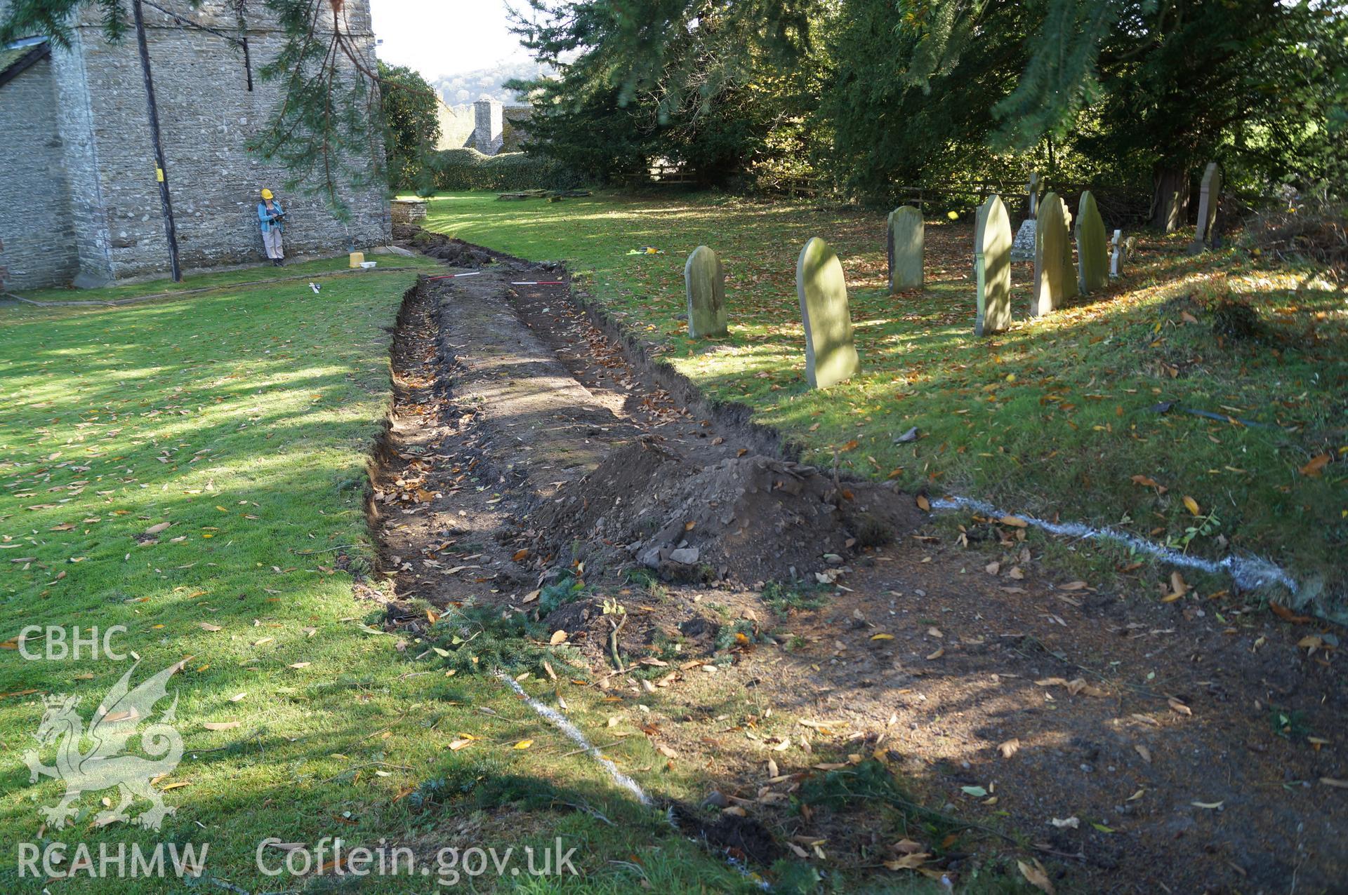 View 'looking east northeast at excavated trenches A and B, and central area of pathway retained' at St. Mary's, Gladestry, Powys. Photograph & description by Jenny Hall and Paul Sambrook of Trysor, 16th October 2017.
