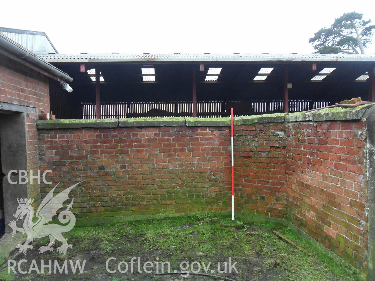 'Inside face of enclosed yard wall, Scale 1x2m, looking south west.' Photographed as part of archaeological desk based assessment and building recording of Nantcribbau Farm, Forden, Powys, undertaken by Archaeology Wales in March 2013. Report no. 1108.