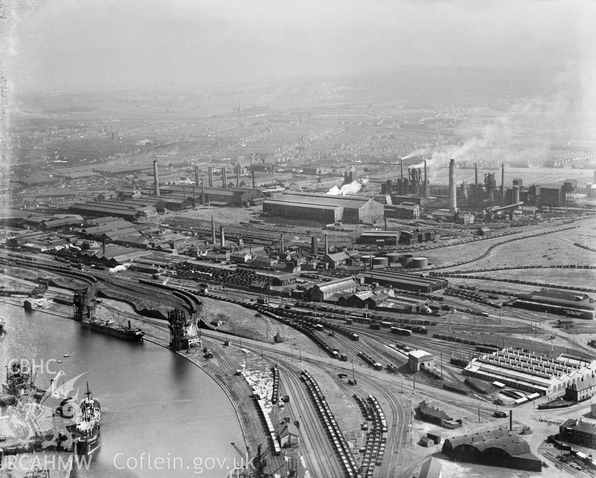Digital copy of a black and white, oblique aerial photograph of East Moors Steelworks, Cardiff. The photograph shows the view from the South. Dowlais Iron Works moved their main production site from Merthyr Tydfil to Cardiff in 1890 for more convenient access to the docks. The works closed in 1978 and the site has since been demolished and partly redeveloped.