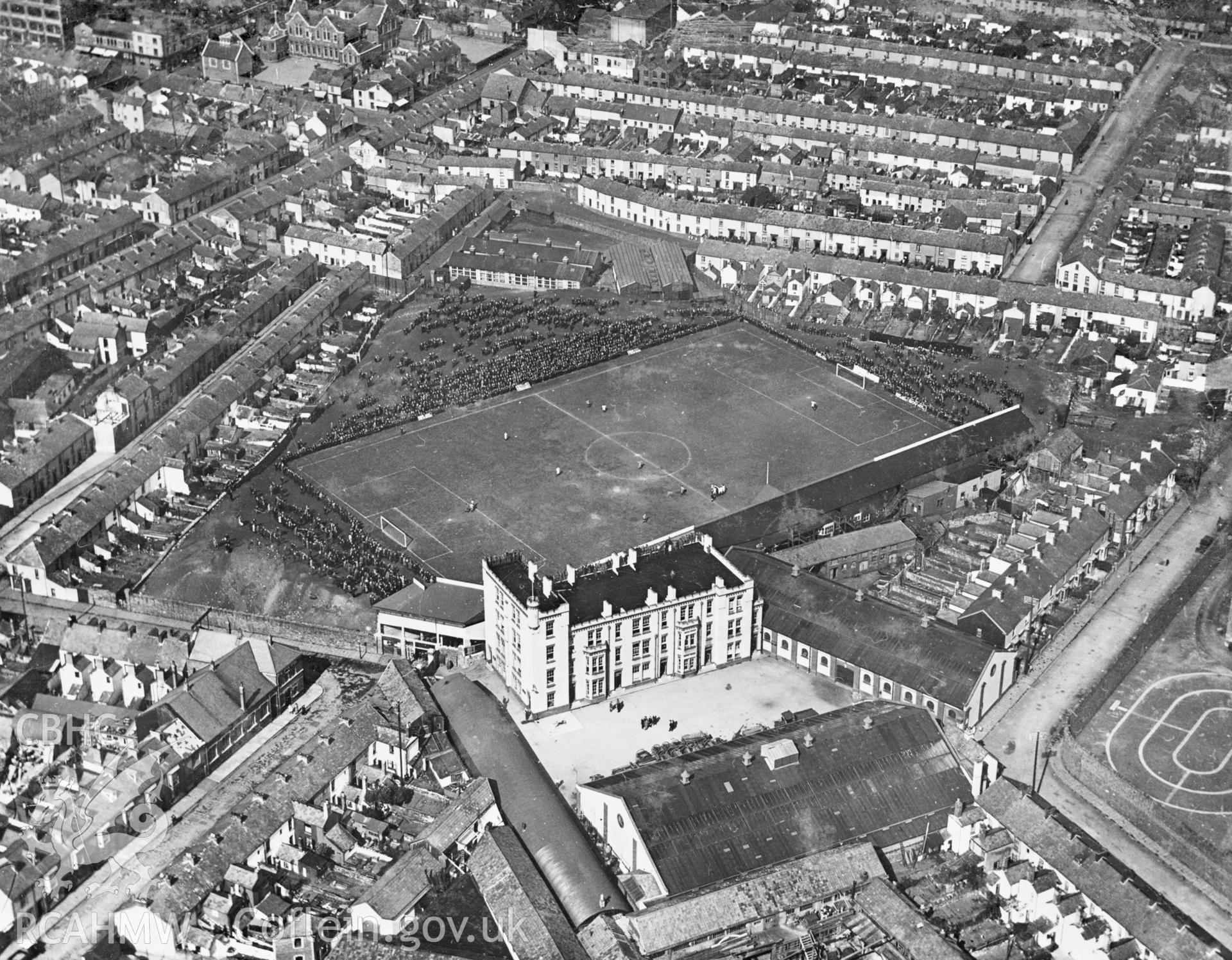 View of Vetch Field football ground, Swansea, showing spectators watching match in progress. Oblique aerial photograph, 5?x4? BW glass plate.