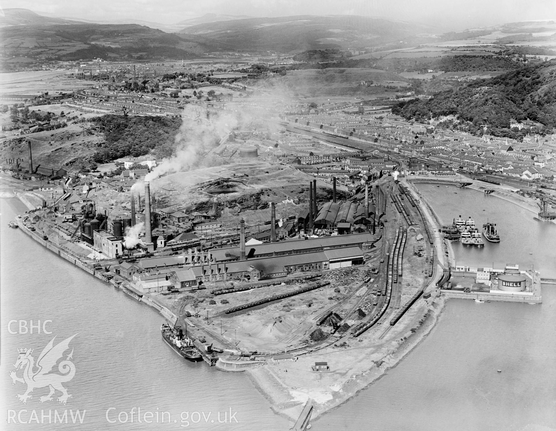 View of Neath River Navigation at Briton Ferry showing Briton Ferry dock, Cambria Cokeworks, Gwalia and Victoria tinplate works and Britain Ferry steelworks, from the northeast, oblique aerial view. 5?x4? black and white glass plate negative.