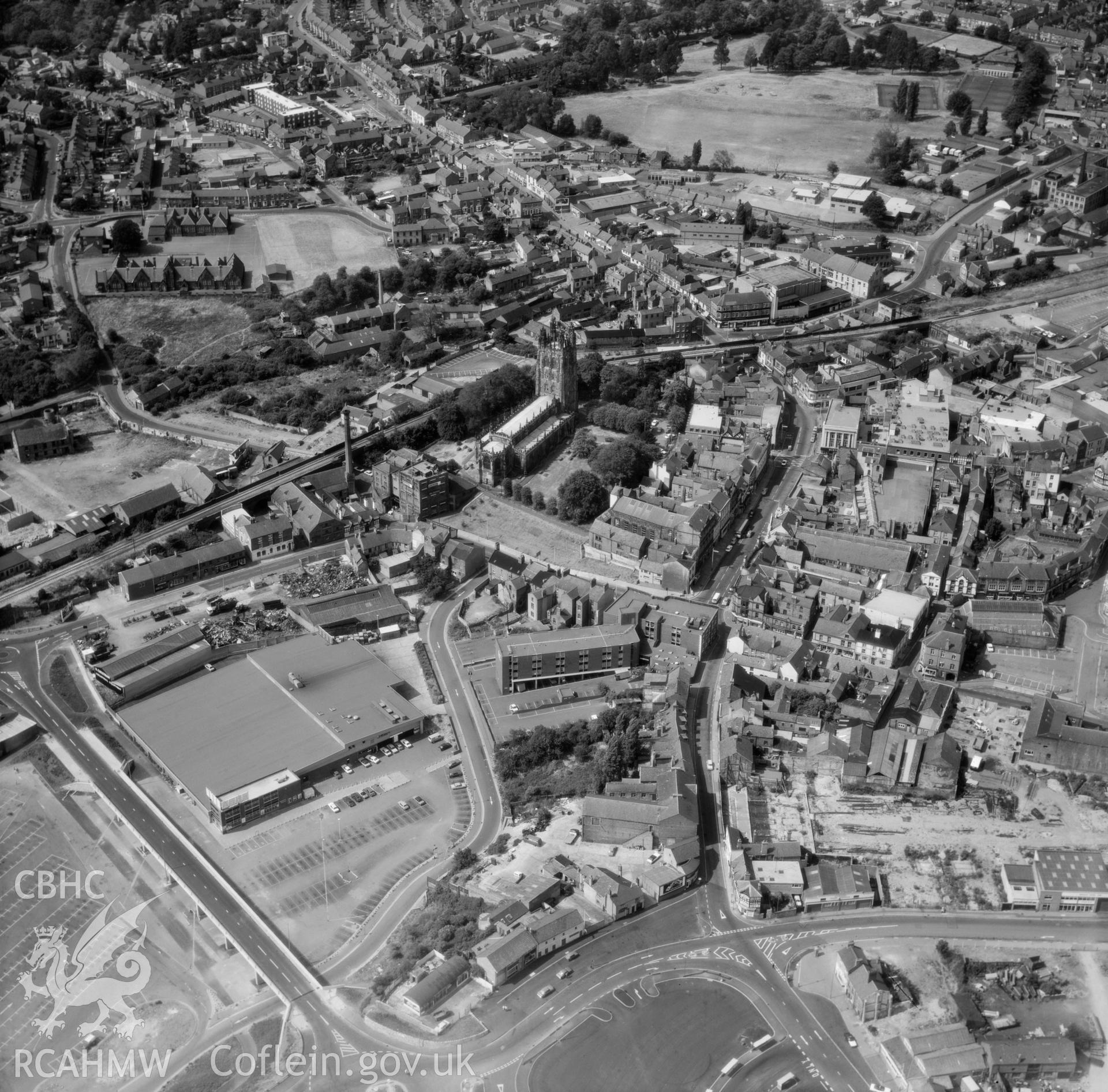 Black and white oblique aerial photograph showing Wrexham, with St Giles Church, from Aerofilms album Caernarvonshire Lland-Z, taken by Aerofilms Ltd and dated 15th June 1950