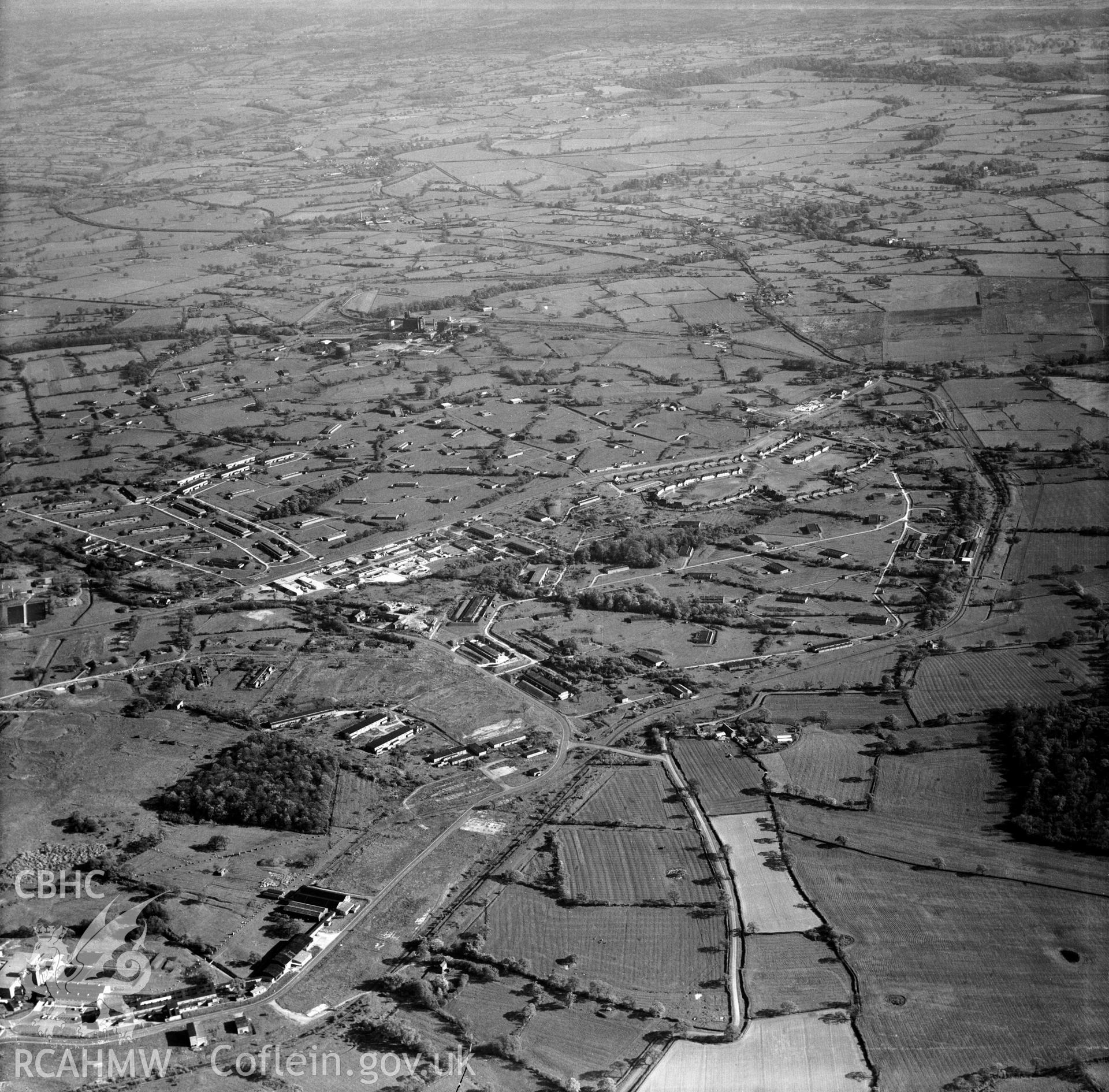 Digital copy of a black and white, oblique aerial photograph of Royal Ordnance Factory, Wrexham. The photograph shows a view from the North showing part of the sprawling World War 2 Ordnance factory. The factory closed in 1945 and the site was adapted for re-use as Wrexham trading estate, now Wrexham Industrial Estate.