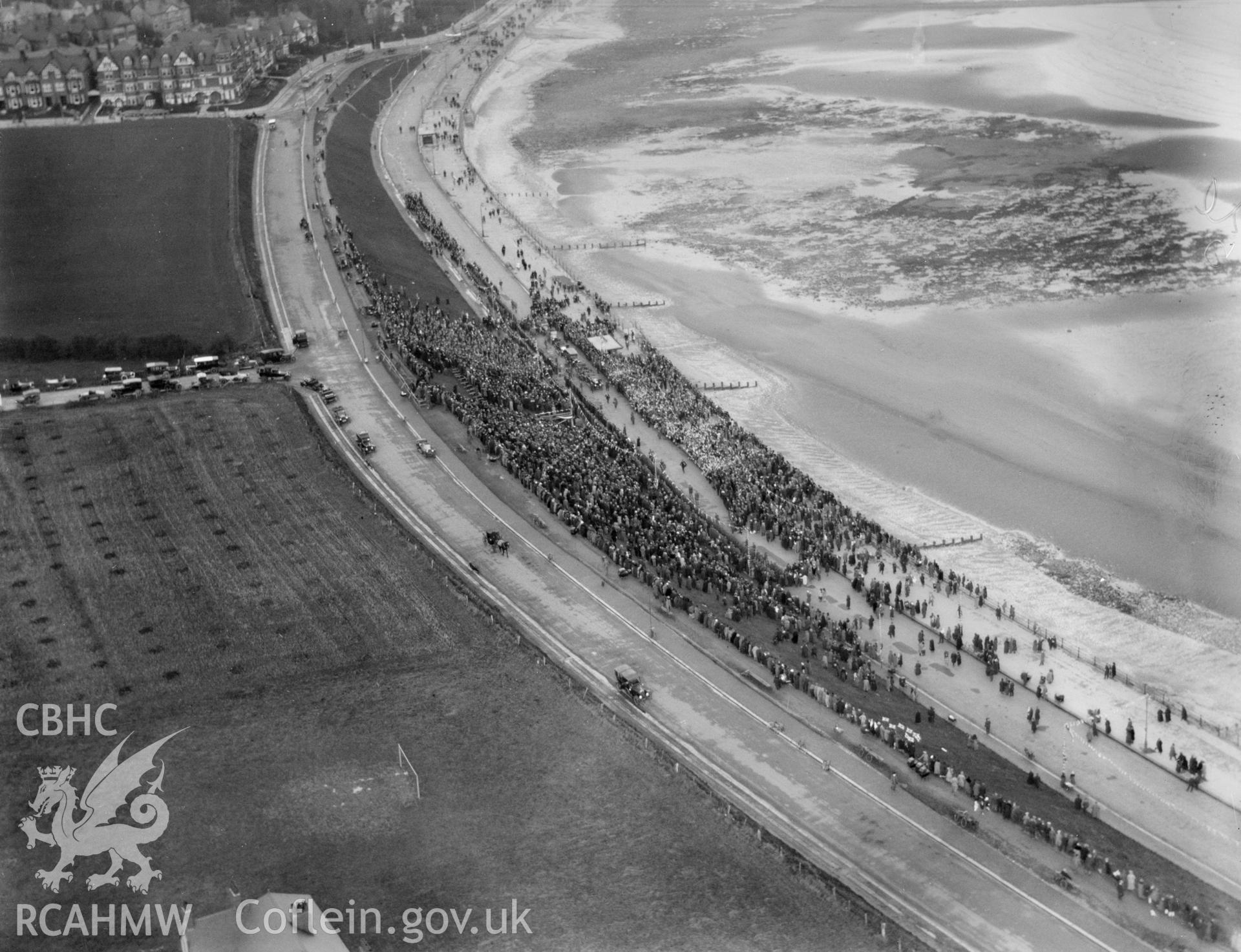Colwyn Bay showing calvalcade of vehicles and crowds during during the visit of the Prince of Wales (later Edward VIII) in November 1923, oblique aerial view. 5?x4? black and white glass plate negative.