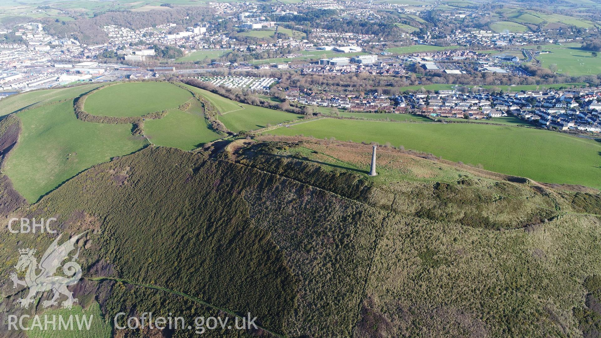 View of Pen Dinas hillfort from the west. CHERISH Project DJI drone photo survey of Pen Dinas Hillfort and the Wellington Monument. ? Crown: CHERISH PROJECT 2017. Produced with EU funds through the Ireland Wales Co-operation Programme 2014-2020. All material made freely available through the Open Government Licence.
