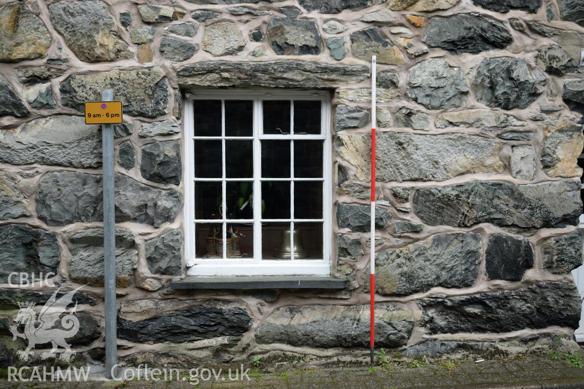 Colour photograph showing view looking south at the ground floor window in the northern elevation of Y Sospan, Llys Owain, Dolgellau. Photographed by I. P. Brookes of Engineering Archaeological Services, June 2019.