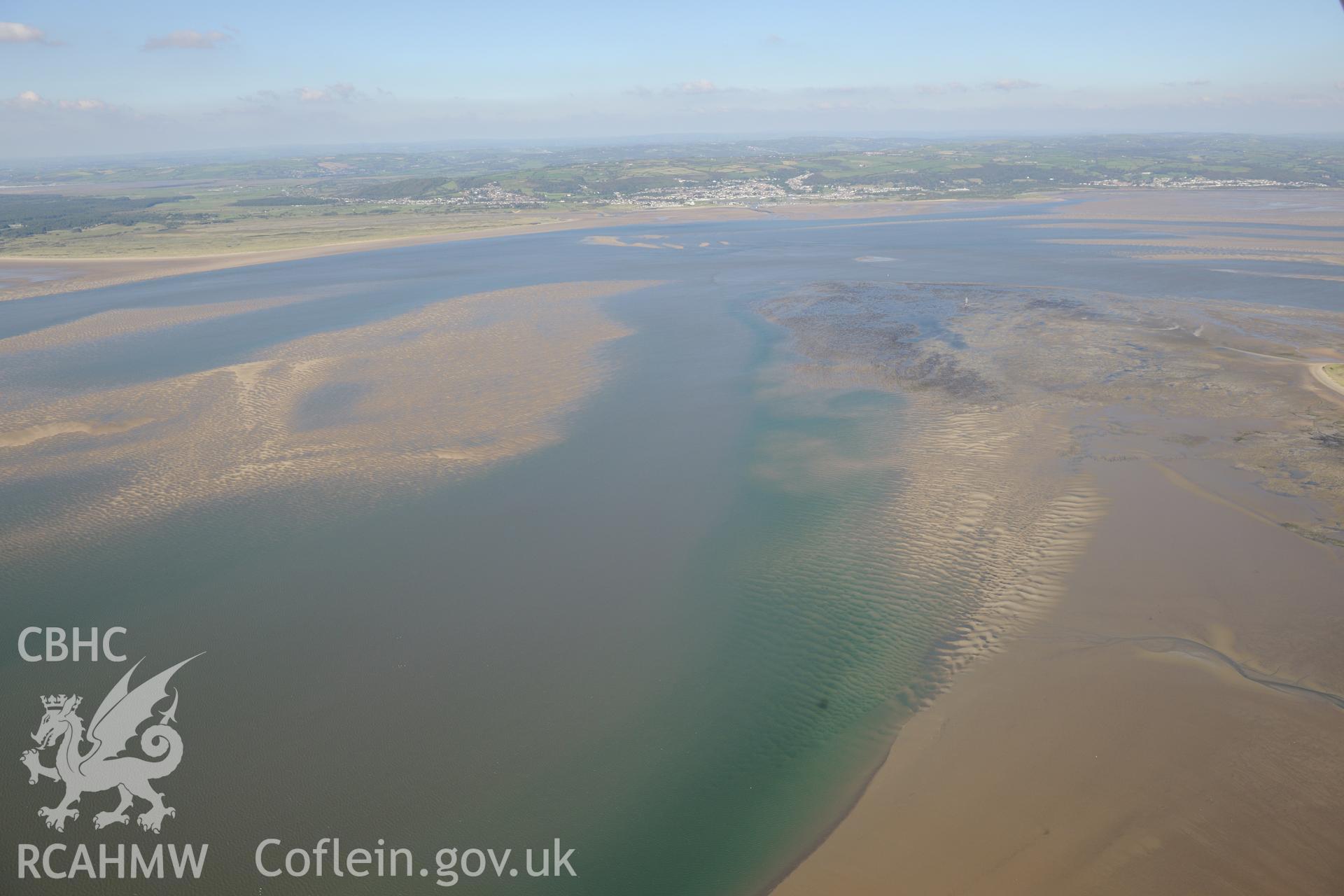 View of Whiteford Sands, looking north towards the distant Burry Port. Top of disused Whiteford Point Lighthouse just visible on the edge of the sands, centre right of photograph. Oblique aerial photograph taken during the Royal Commission's programme of archaeological aerial reconnaissance by Toby Driver on 30th September 2015.