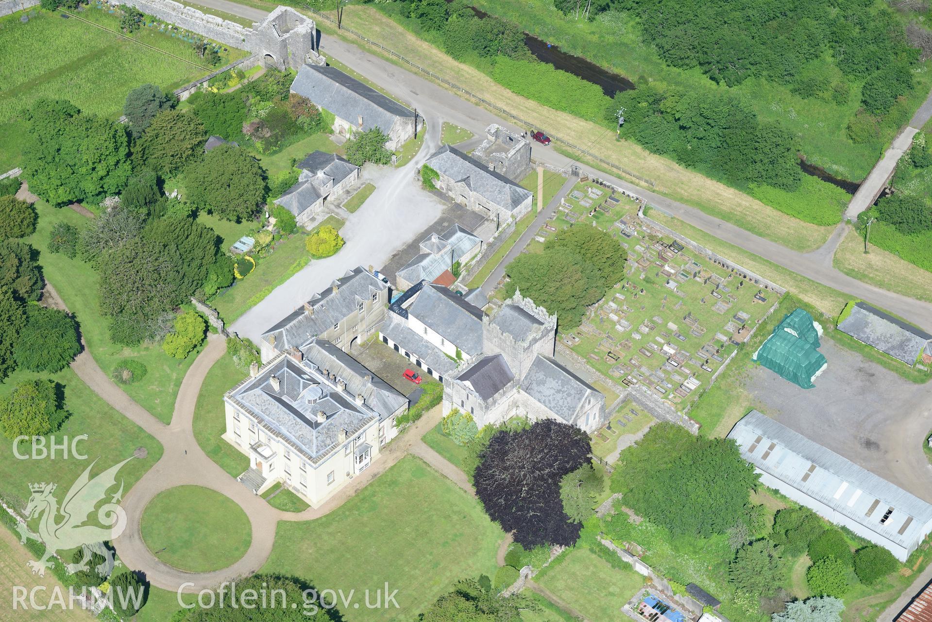 Ewenny Priory including views of the south and north gatehouses; Priory House; north tower and St. Michael's church. Oblique aerial photograph taken during the Royal Commission's programme of archaeological aerial reconnaissance by Toby Driver on 19th June 2015.