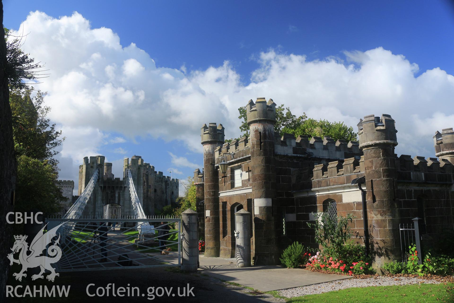 Investigator photographs of Conwy Suspension Bridge Keepers cottage. Exterior: gatekeeper's cottage and closed toll gate with Thomas Telford's iconic sunburst design.