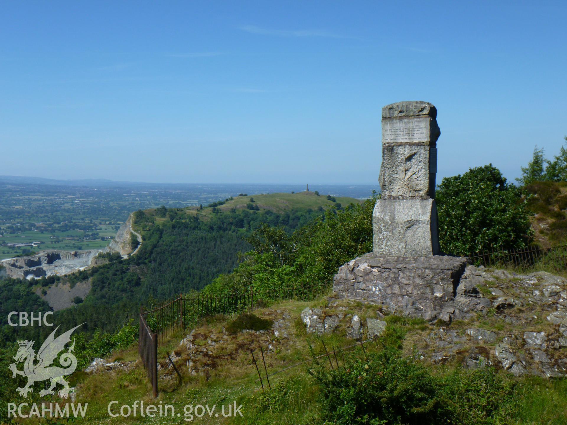 Photograph of the Romany monument to Ernest Burton looking towards the North with Criggion Quarry and Rodney's Pillar visible in the background.