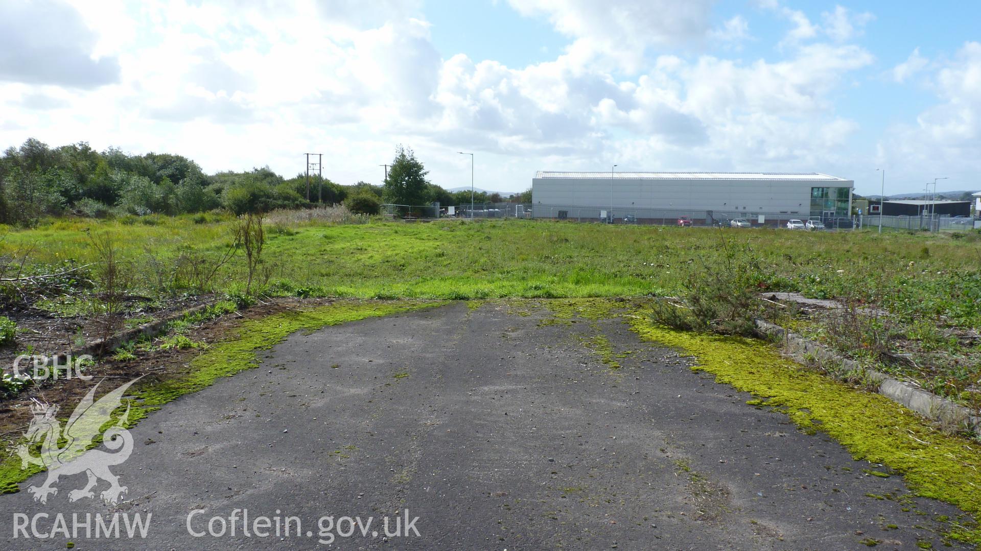 View southwest across southern edge of proposed development site toward Carn Coch, showing unit blocking view. Photographed for Setting Impact Assessment of land near Garngoch Business Village, Swansea, by Archaeology Wales, 2018. Project no. P2631.