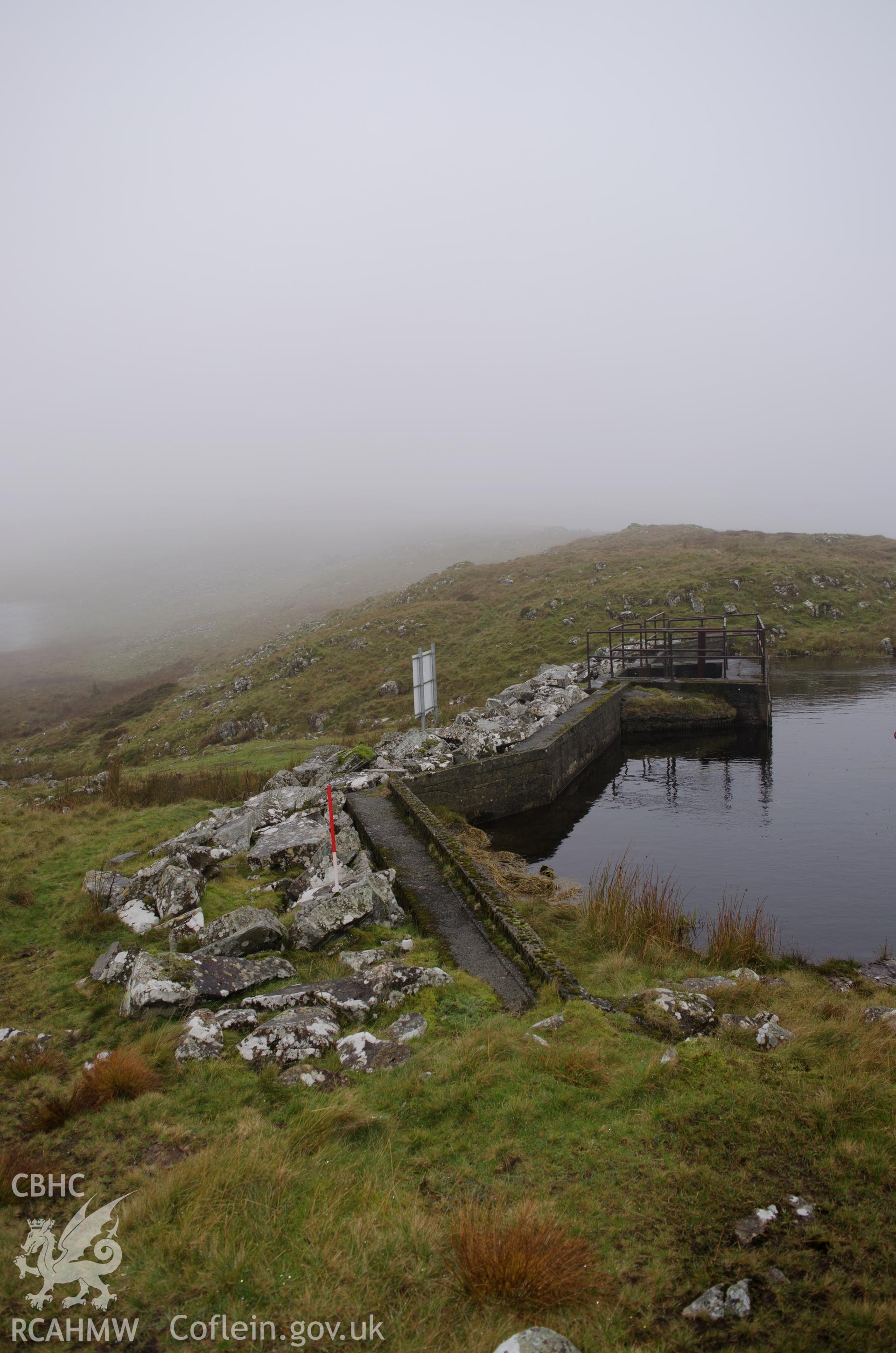 General view from the east of Gelli Gain reservoir dam, Trawsfynydd. Photographed as part of archaeological assessment conducted by Gwynedd Archaeological Trust on 16th October 2018. Project no. 2579.