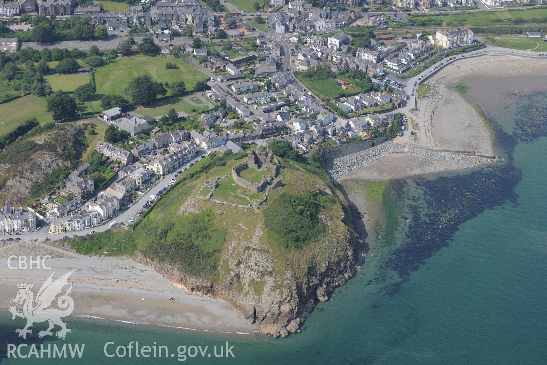 Criccieth Castle, overlooking the town of Criccieth, with Capel y Traeth Calvinistic Methodist Chapel near top of photograph. Oblique aerial photograph taken during RCAHMW?s programme of archaeological aerial reconnaissance by Toby Driver, 12th July 2013.