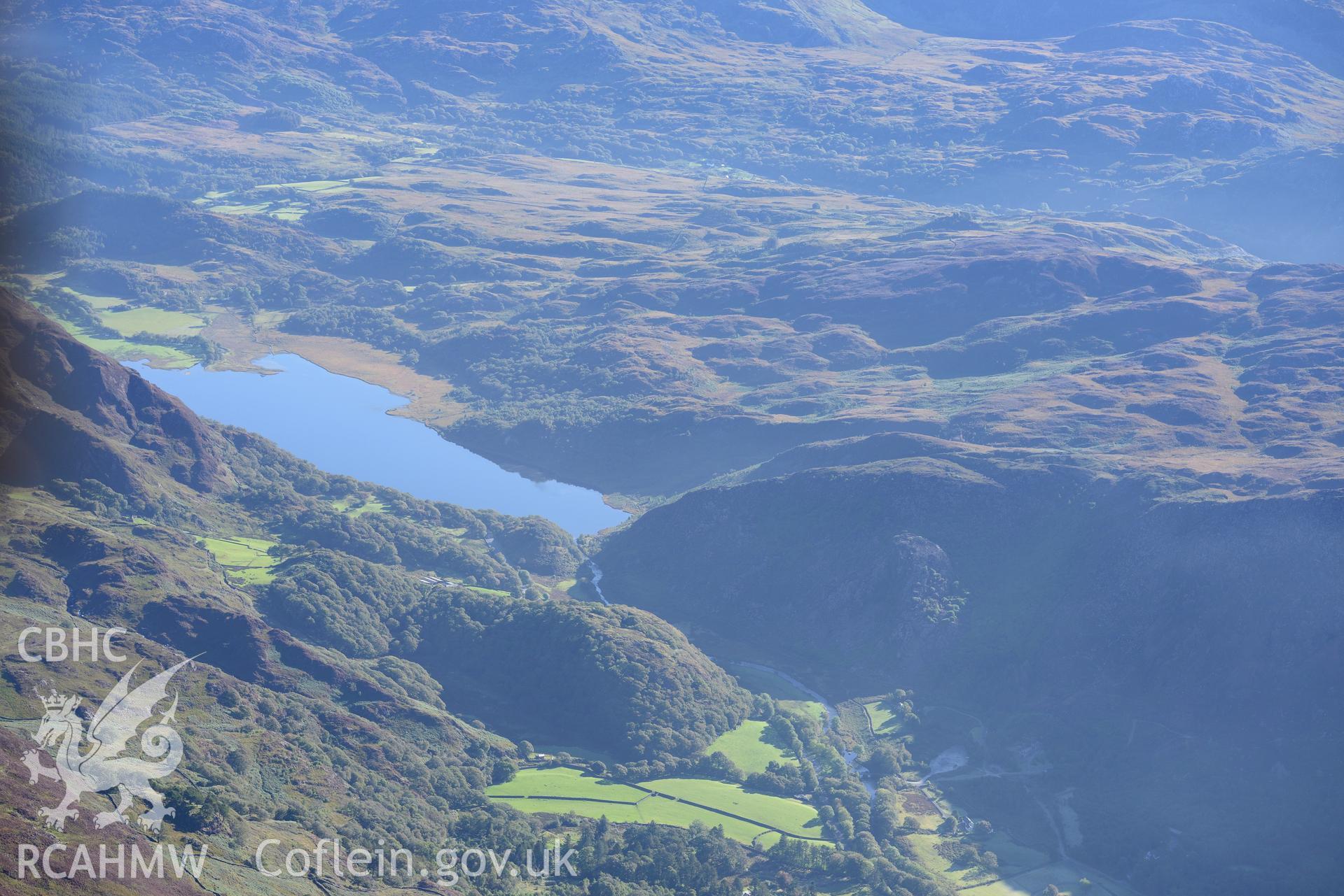 Dinas Emrys hillfort and Llyn Dinas near Beddgelert. Oblique aerial photograph taken during the Royal Commission's programme of archaeological aerial reconnaissance by Toby Driver on 2nd October 2015.