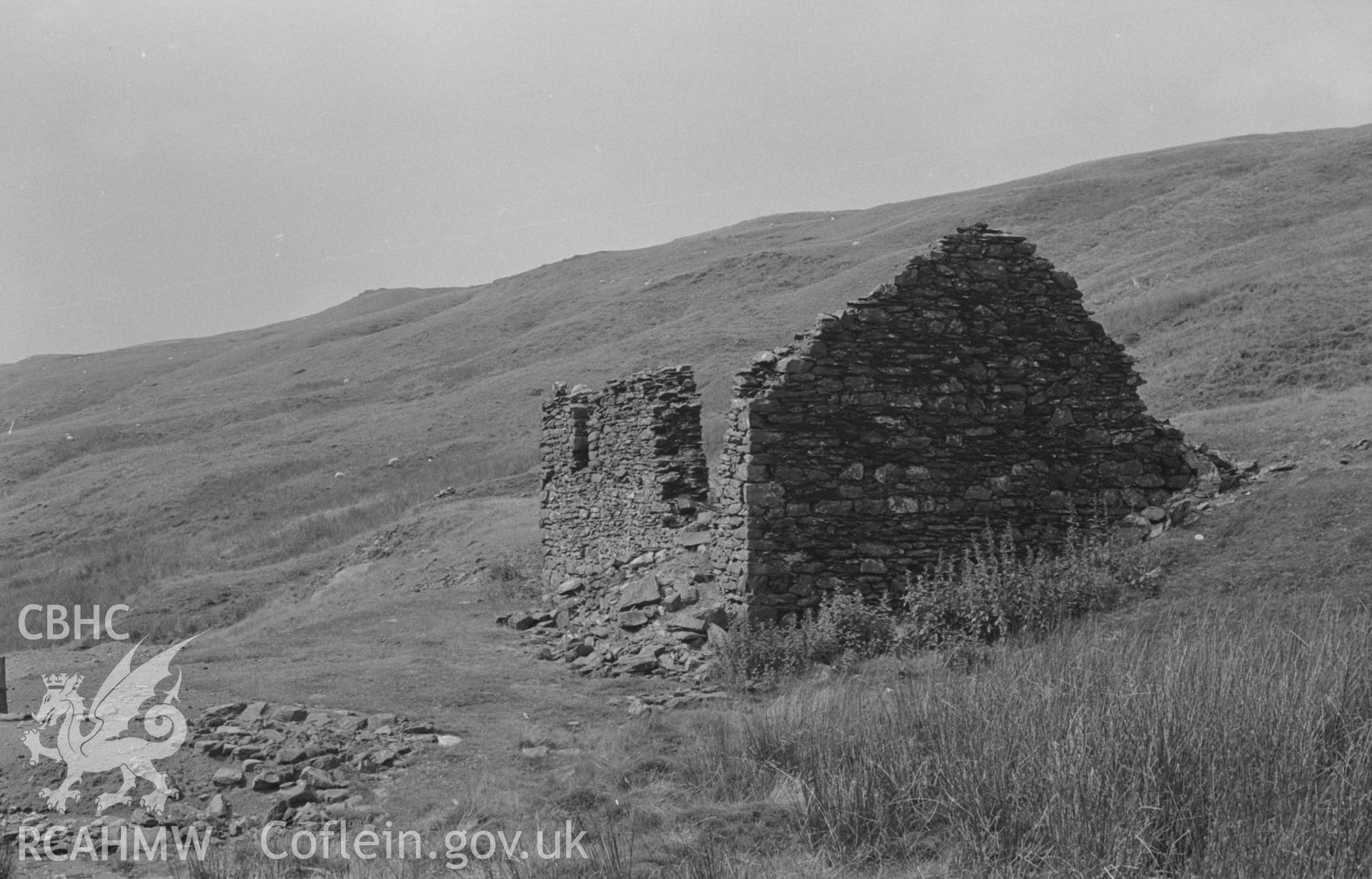 Digital copy of a black and white negative showing ruined building by track on west side of Pumlumon mine. Photographed by Arthur O. Chater in August 1967. (Looking south west from Grid Reference SN 795 865).