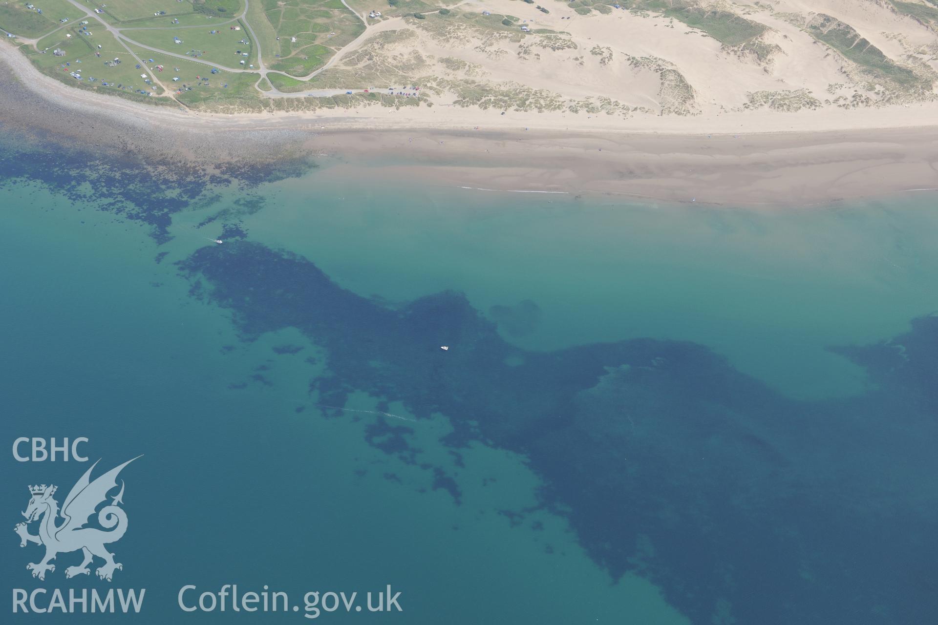 Sarn Padrig Reef and Mochras Spit, off the coast of Llaneddwyn, Dyffryn Ardudwy, Gwynedd. Oblique aerial photograph taken during the Royal Commission?s programme of archaeological aerial reconnaissance by Toby Driver on 12th July 2013.