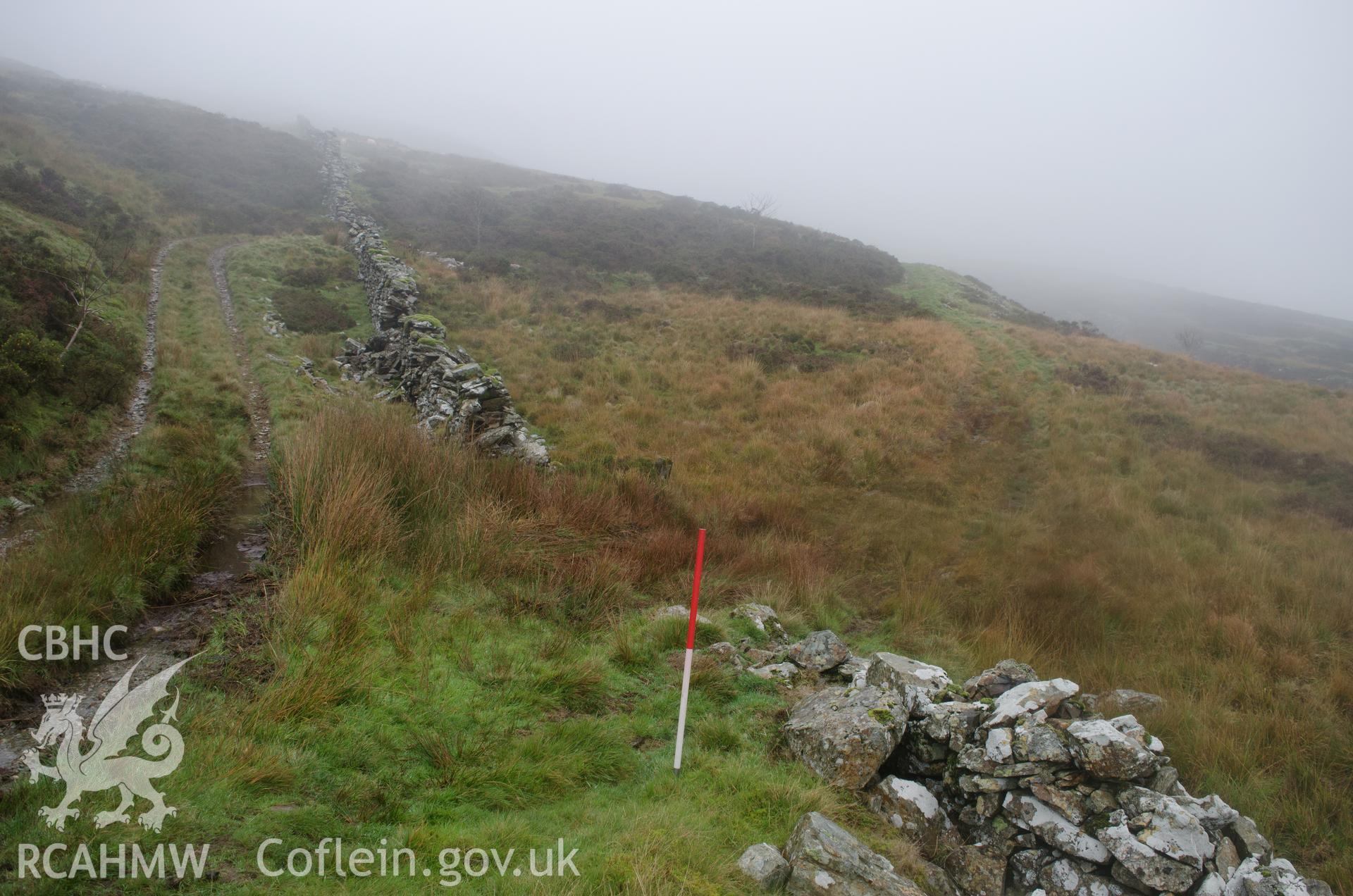 View from the north of north-south drystone wall at Llyn Gelli-Gain, Trawsfynydd. Photographed as part of archaeological assessment conducted by Gwynedd Archaeological Trust on 16th October 2018. Project no. 2579.