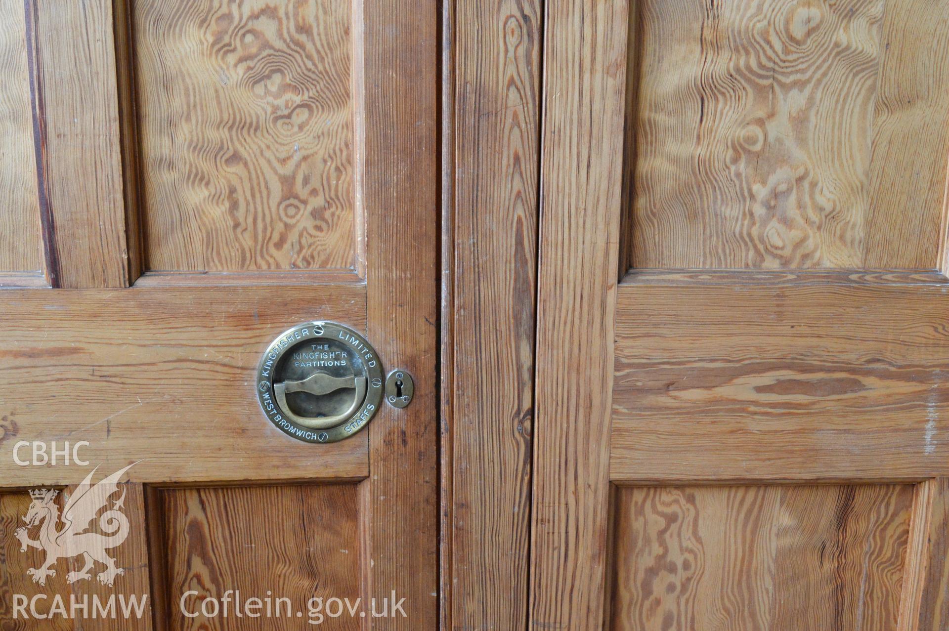 Internal view of detail of wooden partition to main hall, door handles. Digital colour photograph taken during CPAT Project 2396 at the United Reformed Church in Northop. Prepared by Clwyd Powys Archaeological Trust, 2018-2019.